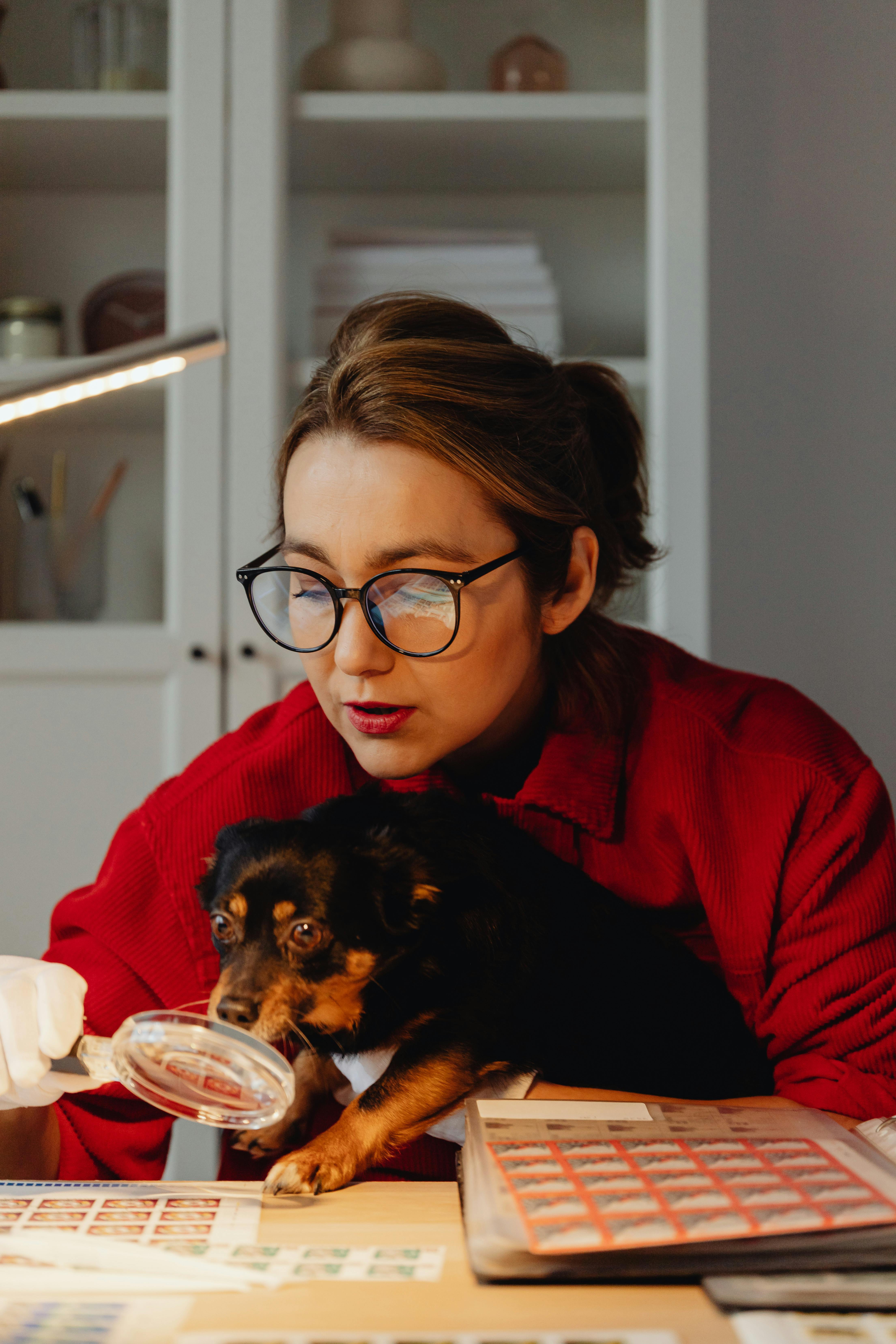 Woman Stamp Collecting With Pet Dog