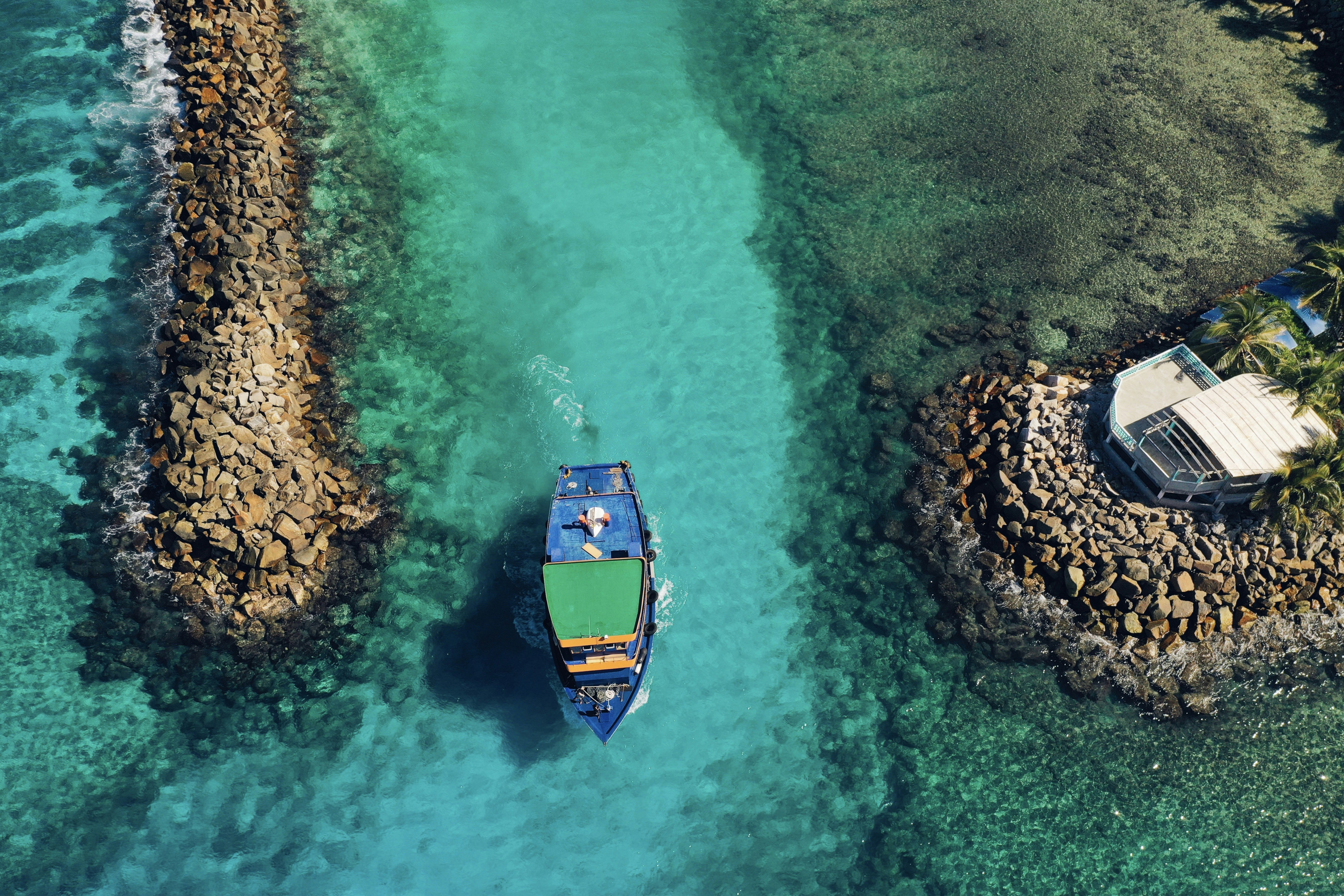 Boat Entering Tropical Harbor Channel