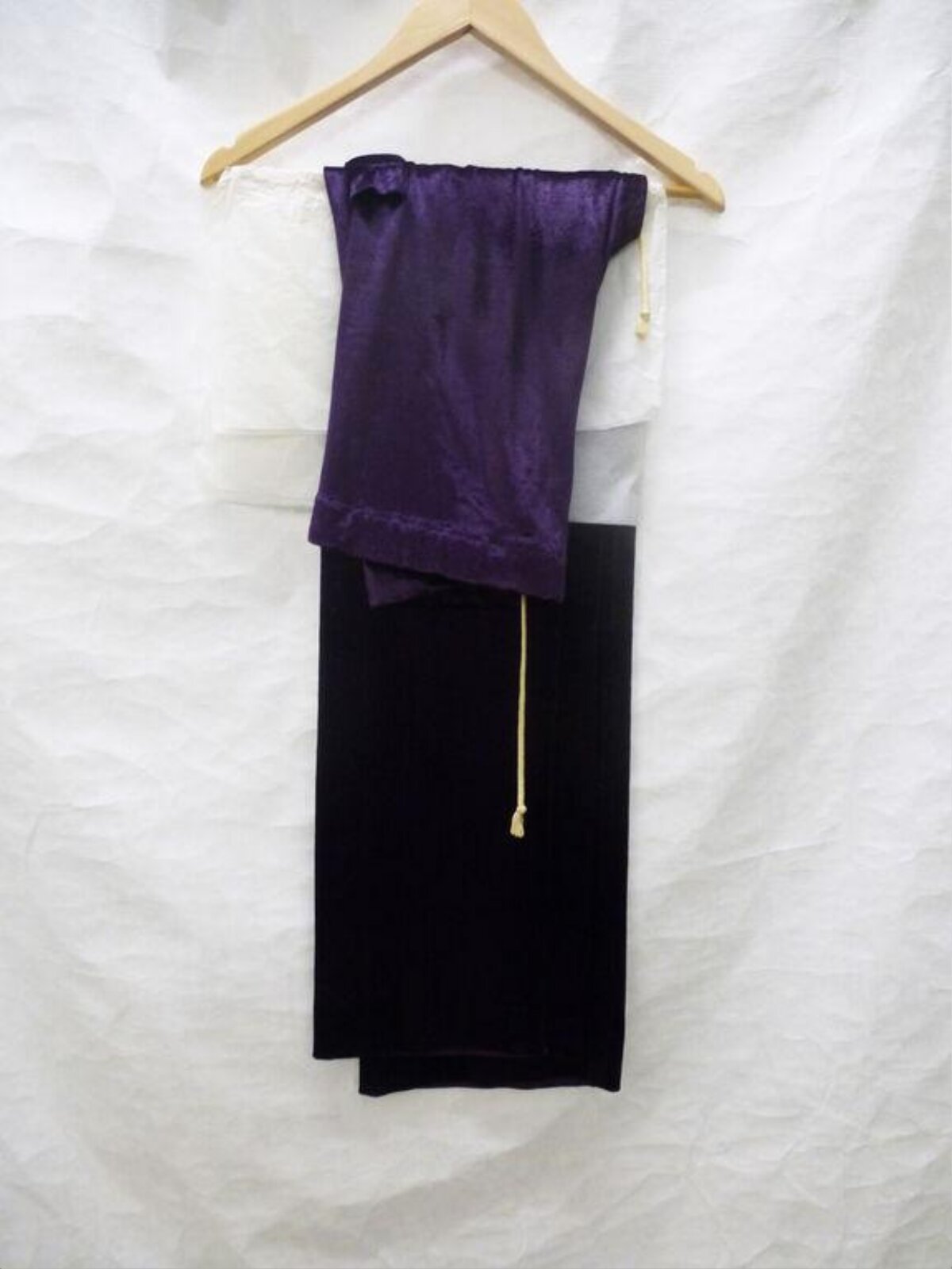 Folded Fabrics Hung on Wooden Hanger