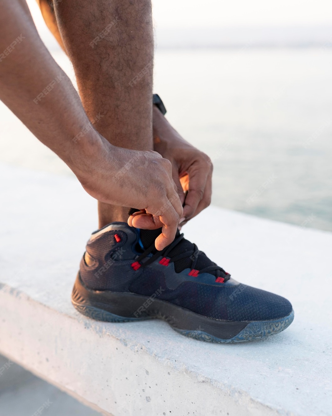 Runner Tying Shoe Laces by Waterfront