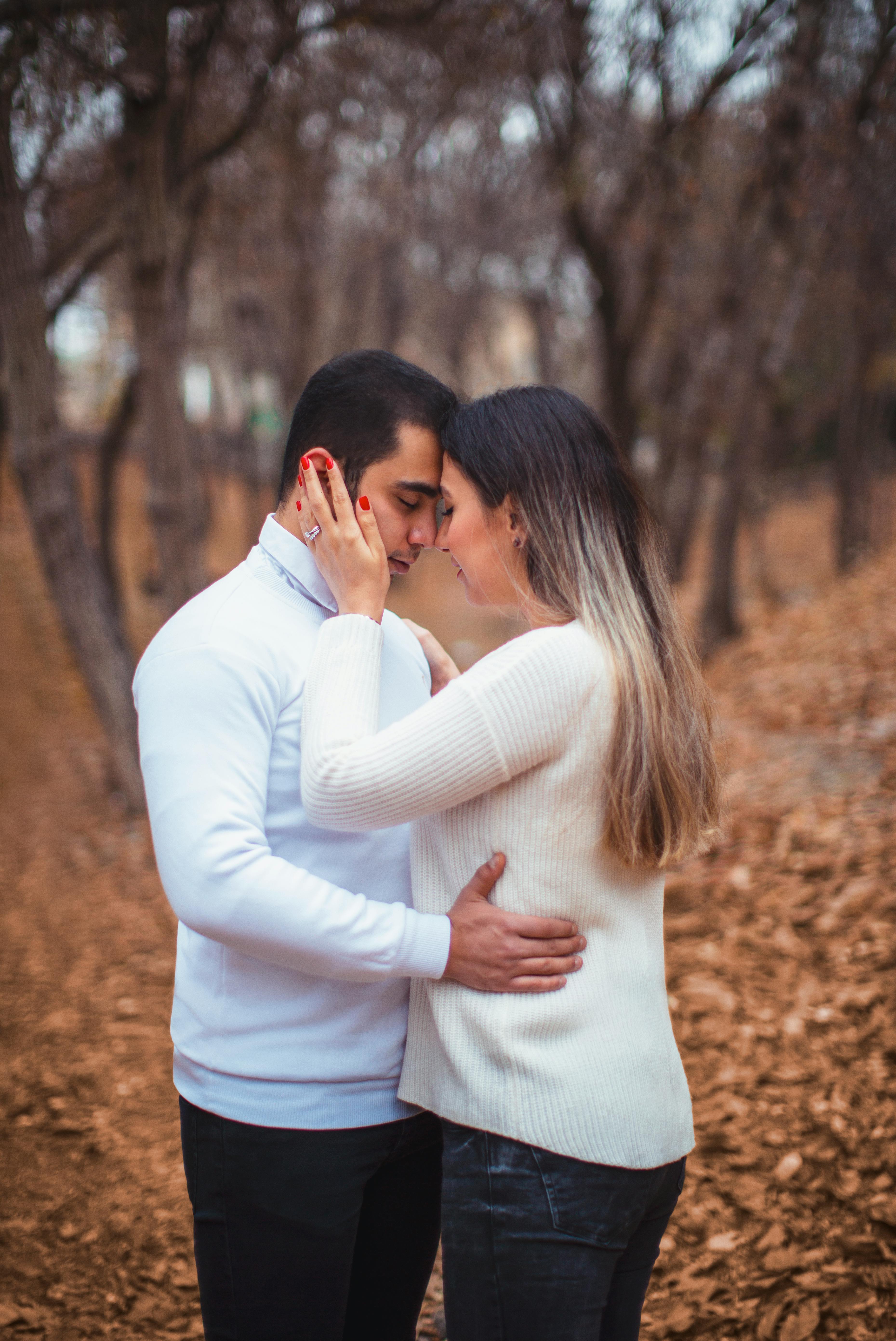 Loving Couple Embracing in Autumn Woods