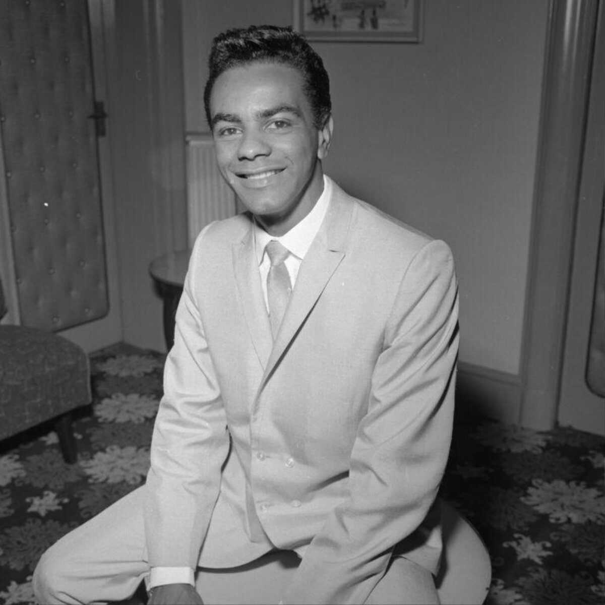 Smiling Seated Man in Formal Suit