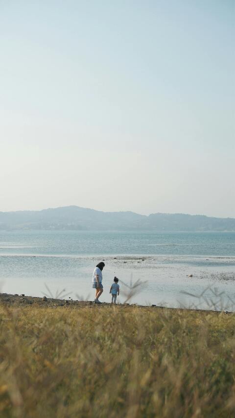 Woman and Child by Calm Lake