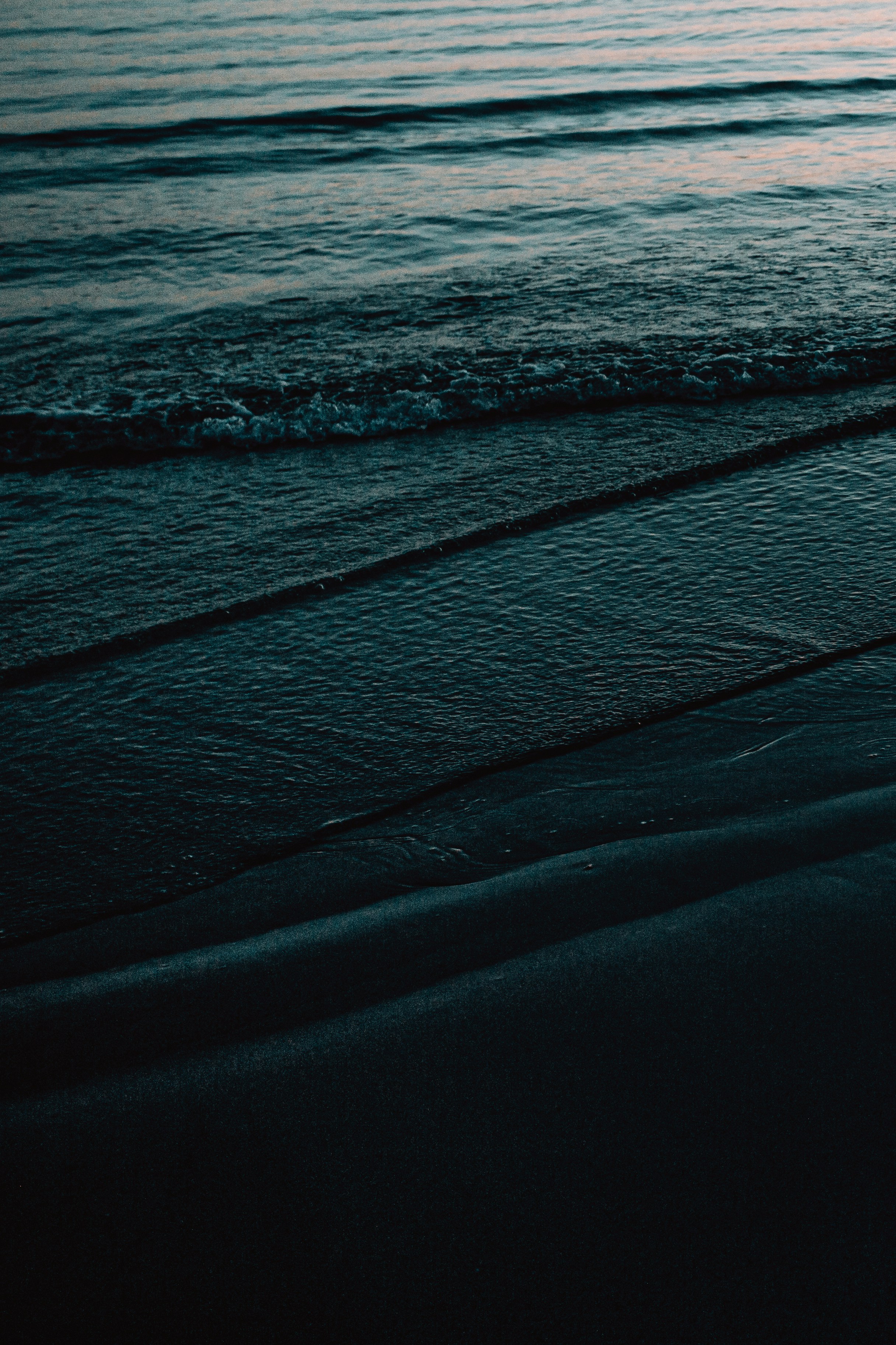 Waves Lapping on Dark Beach
