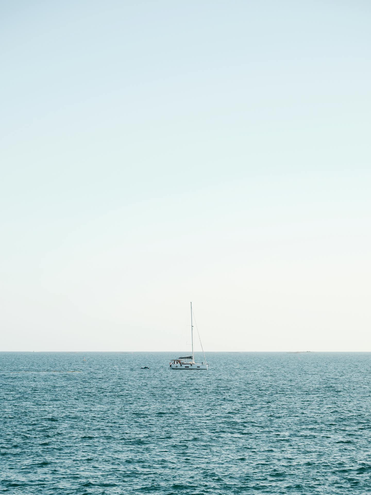Lone Sailboat on Open Sea