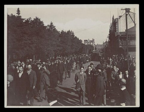 Vintage Procession of Men on City Street
