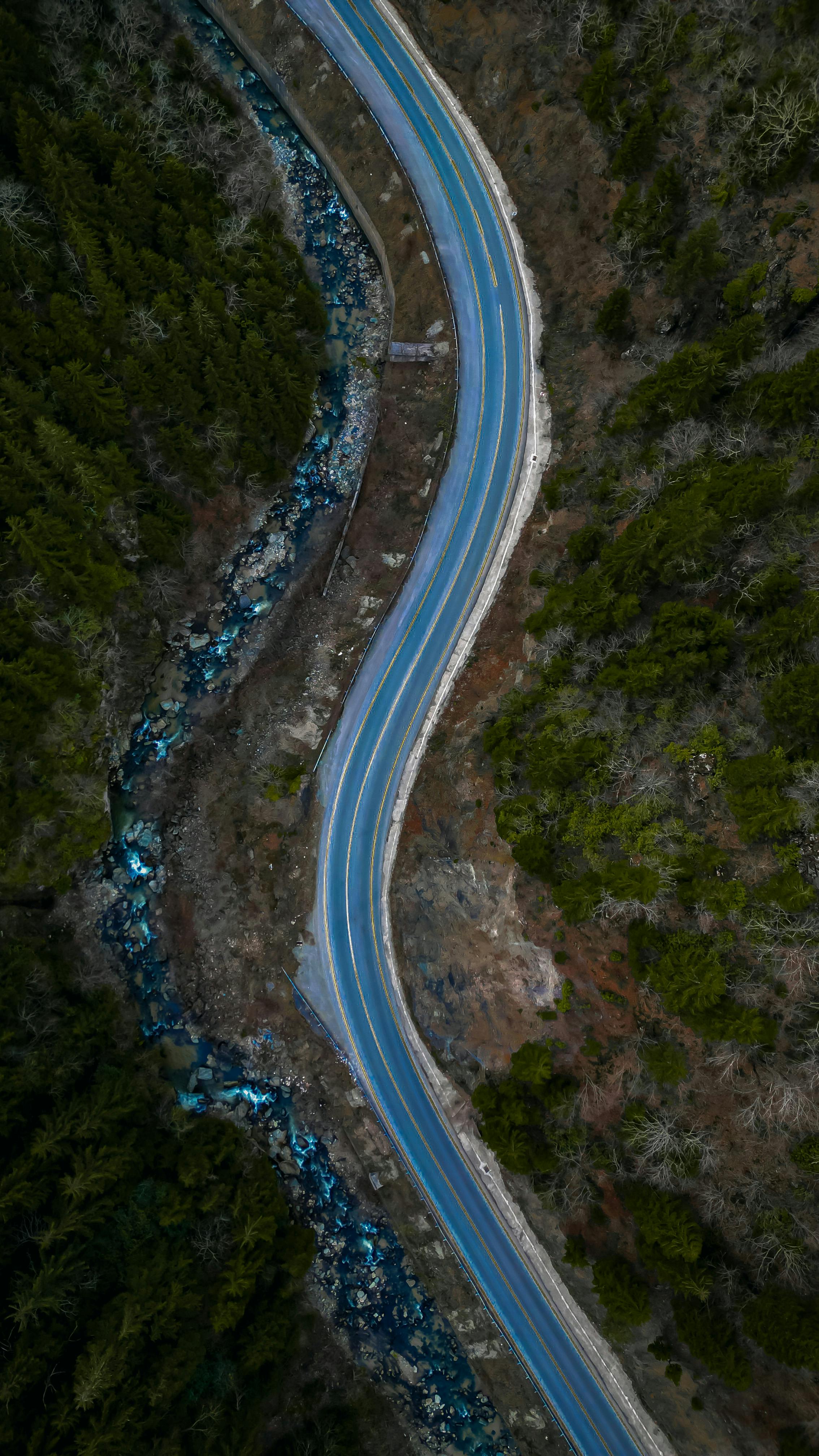 Aerial View of Winding Road Beside Stream