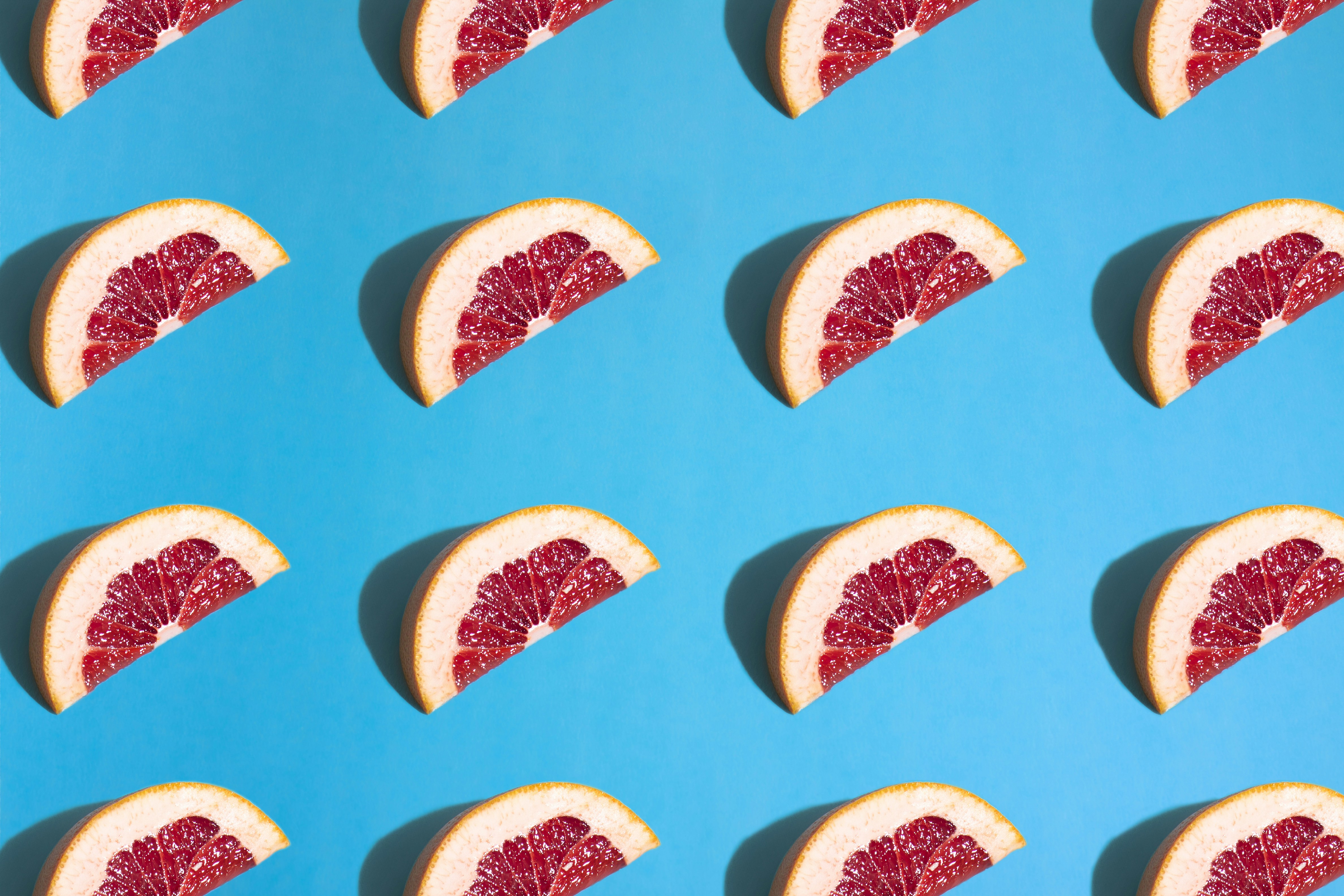Grapefruit Slices Pattern on Blue Background