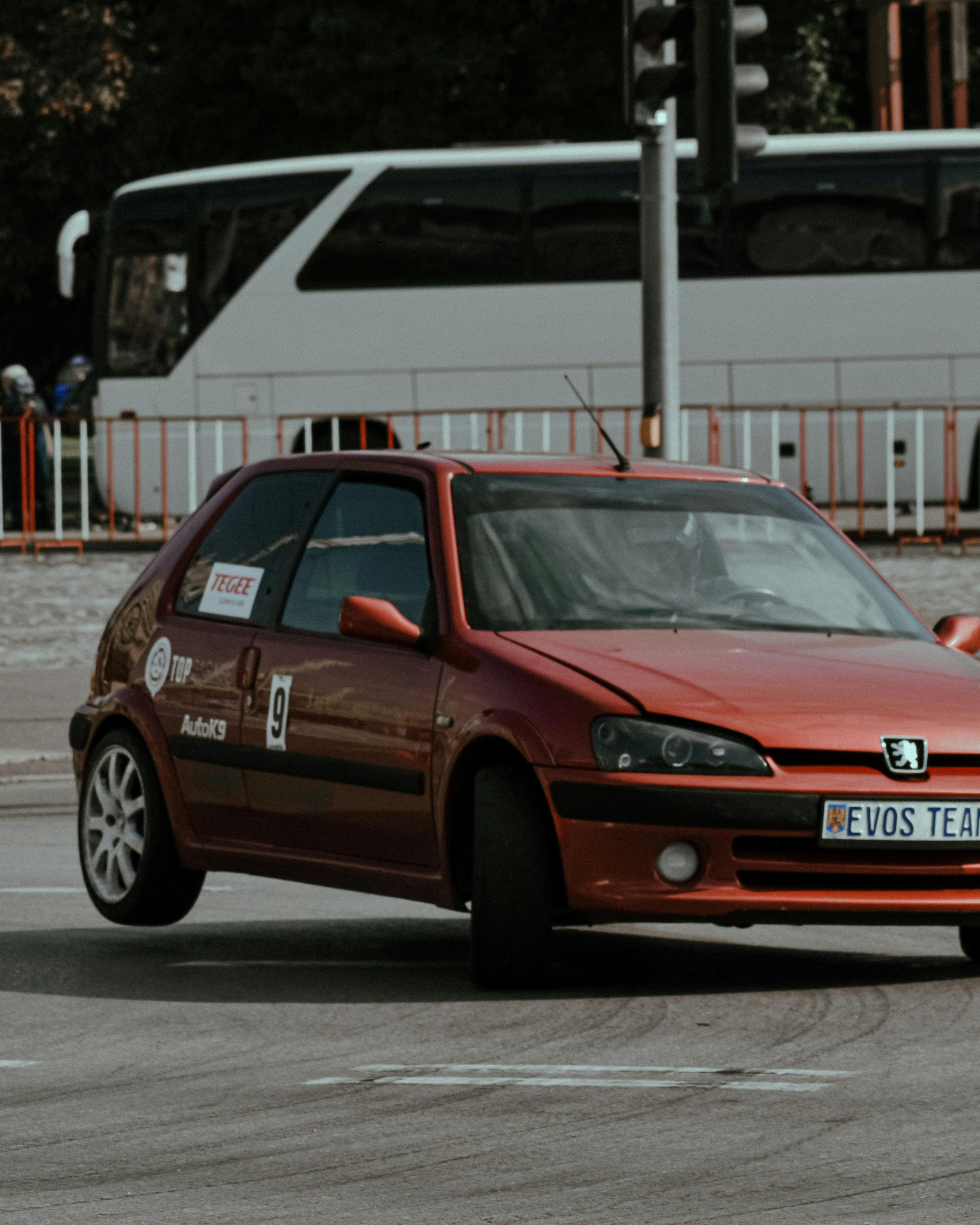 Red Racing Peugeot on City Road
