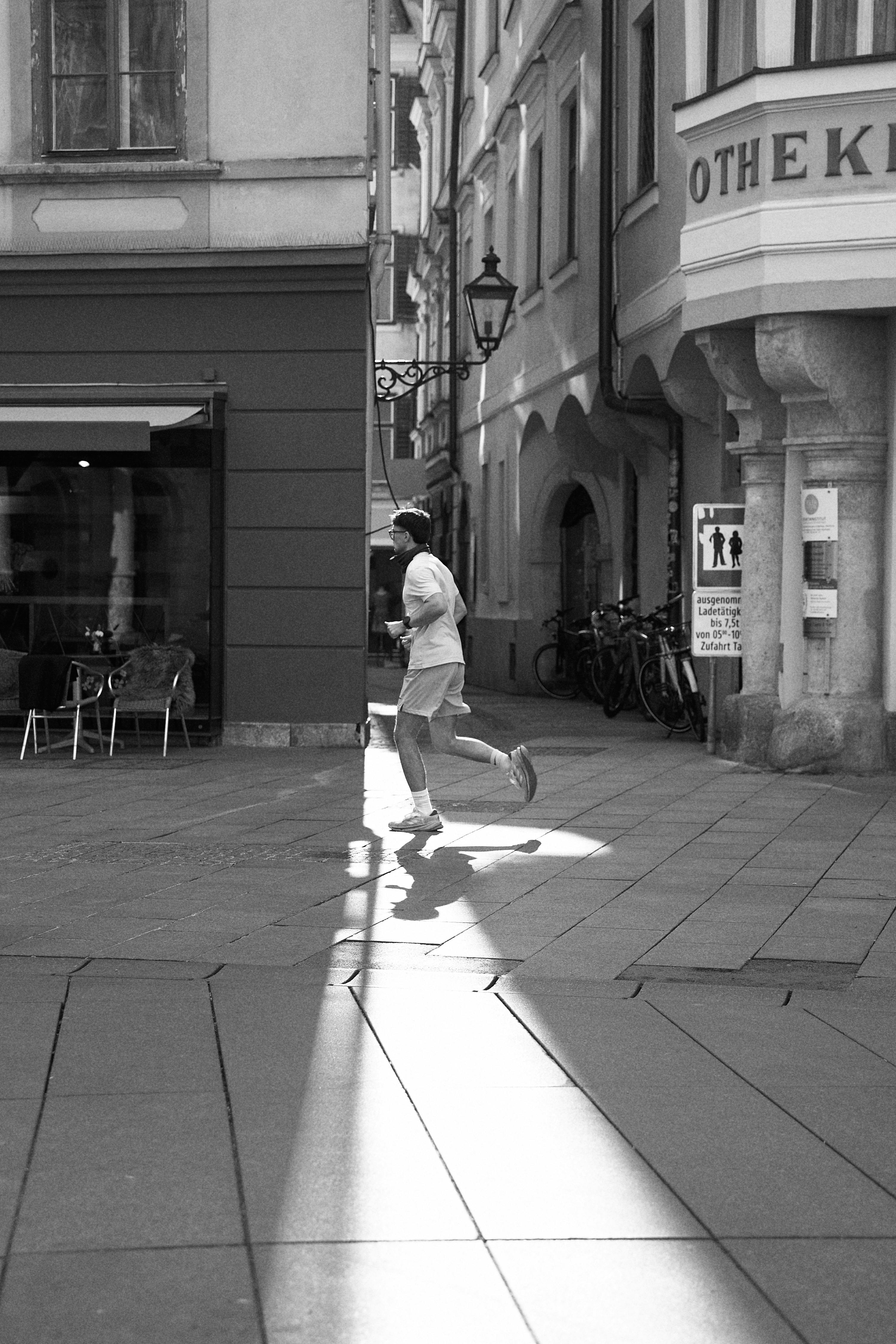 Jogger Running Through Old City Street