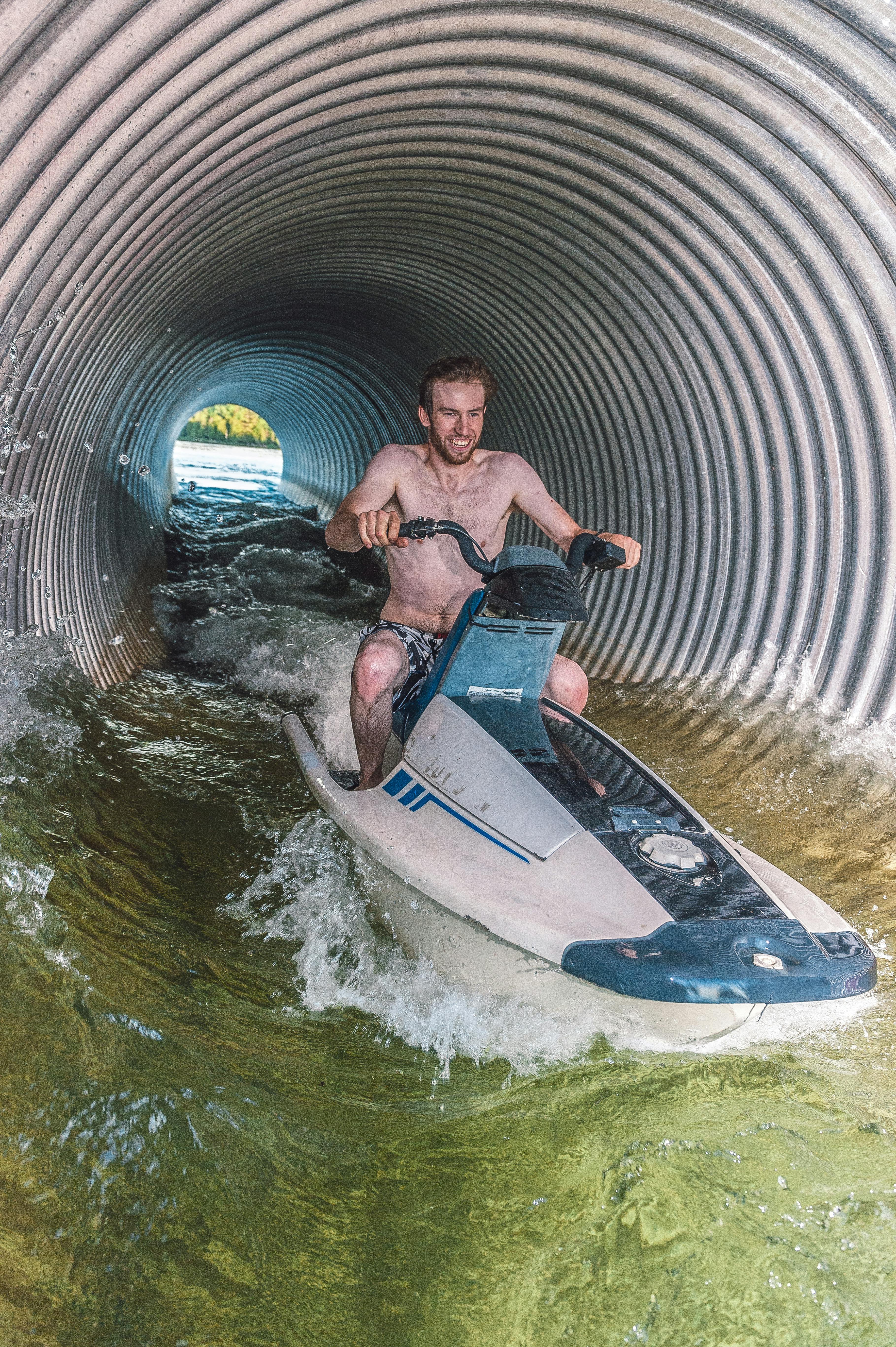 Man Jet Skiing Through a Metal Tunnel