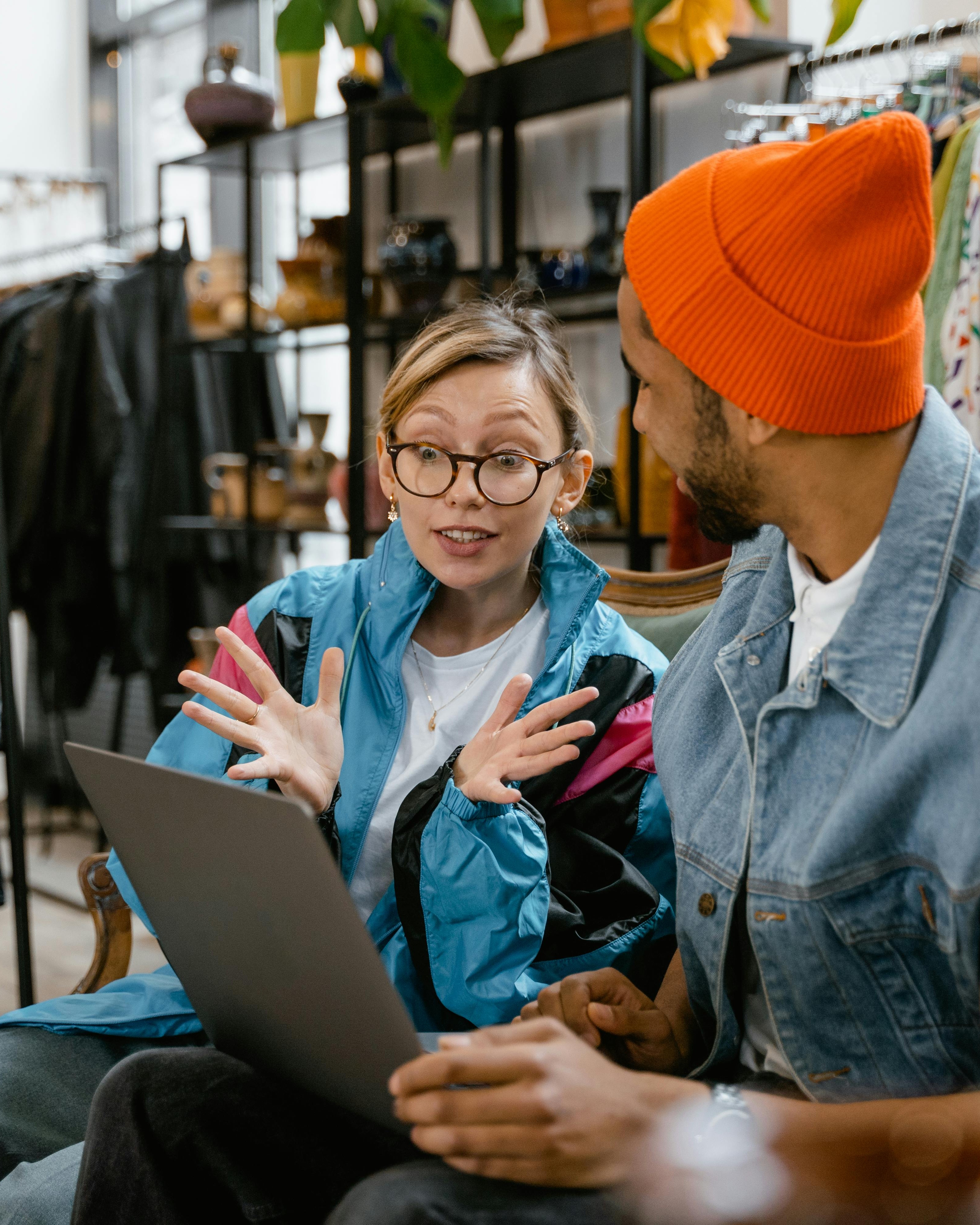 Two People Discussing Content on Laptop