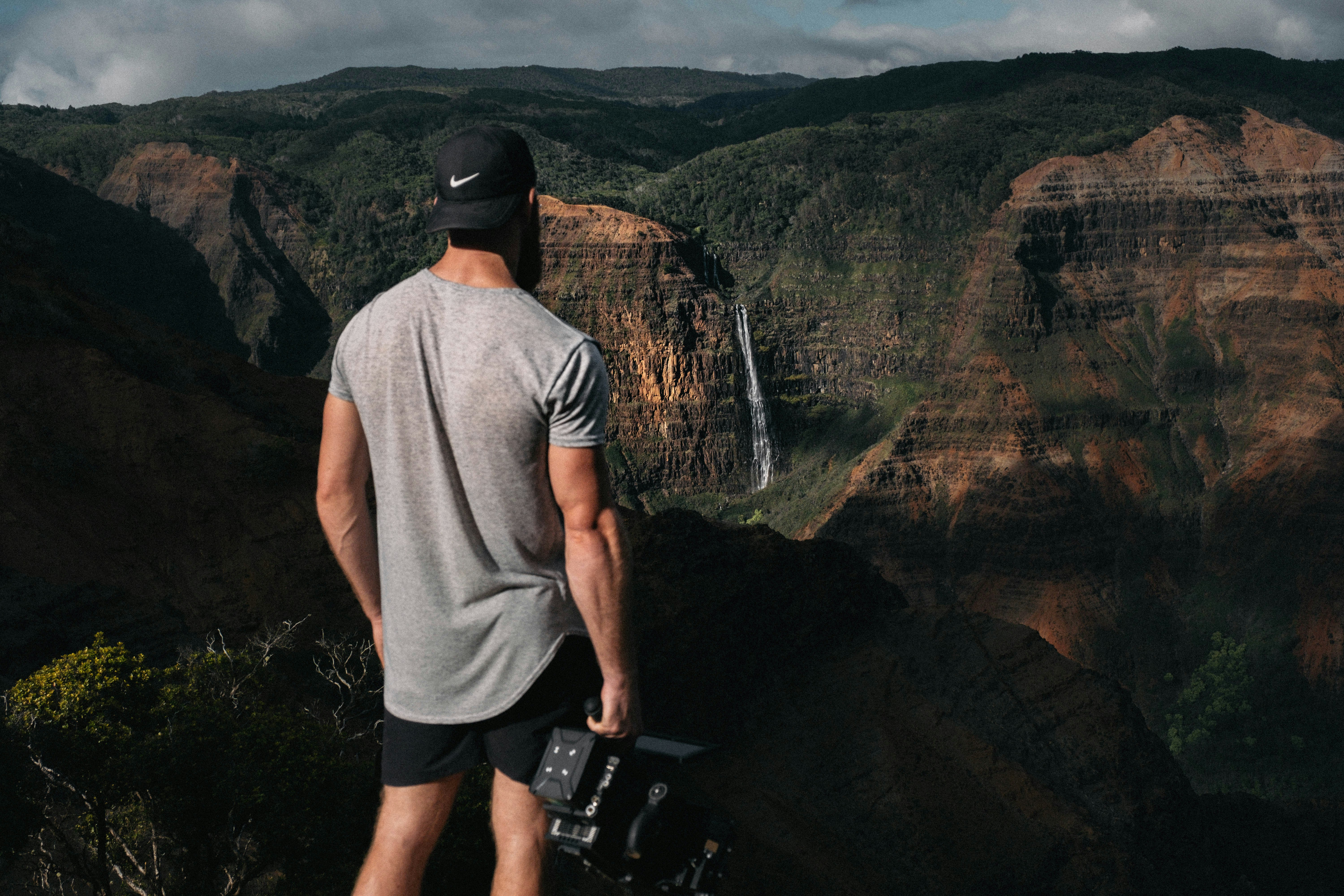 Photographer Overlooking Canyon Waterfall