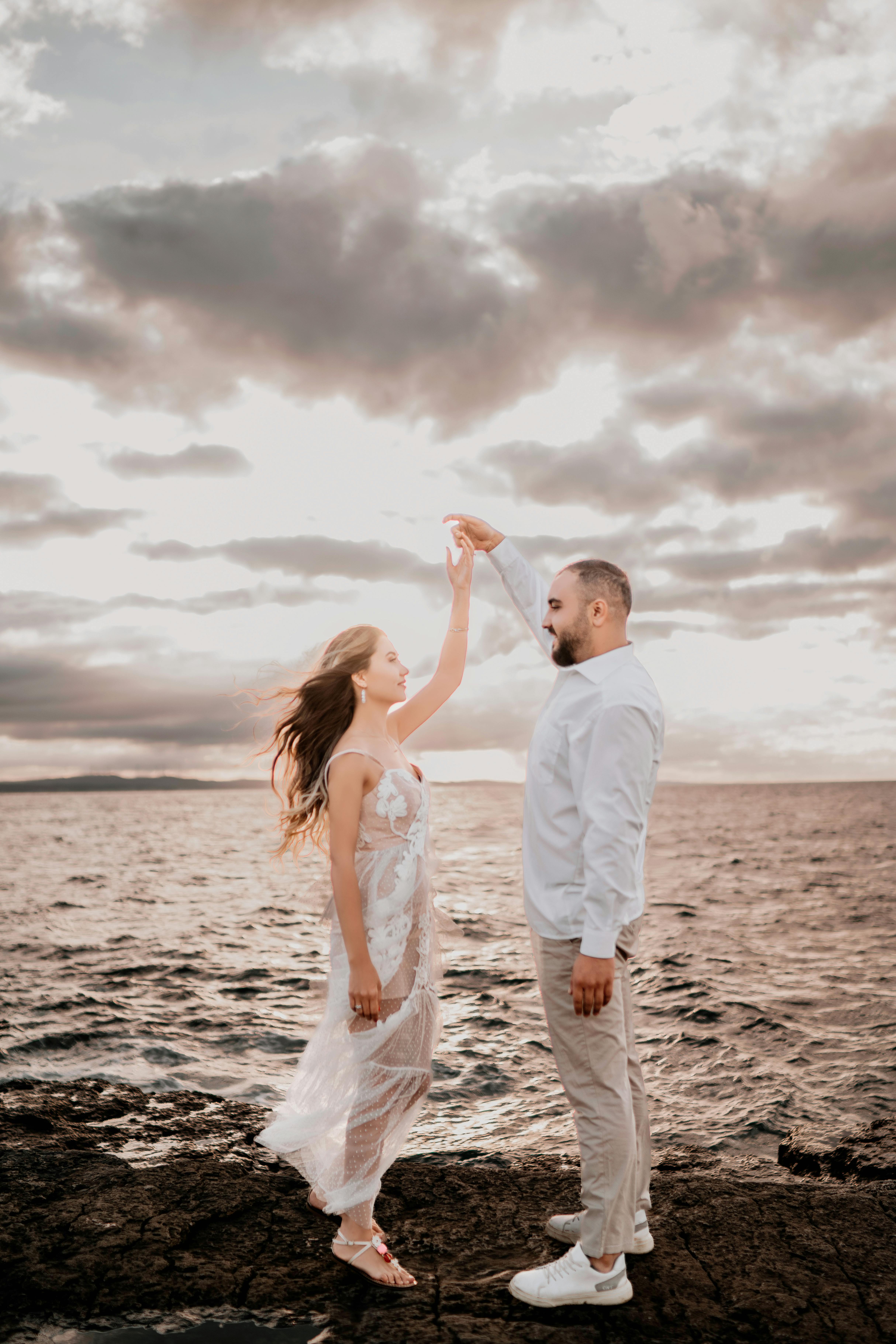 Couple Dancing by the Sea at Sunset