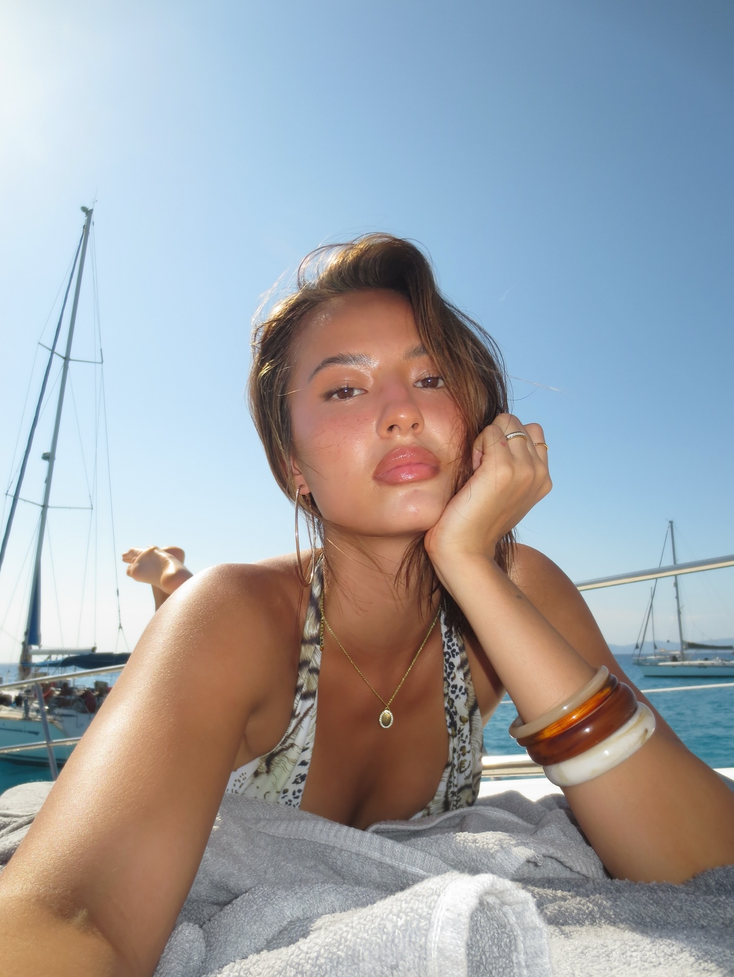 Woman Relaxing on Sailboat at Sea