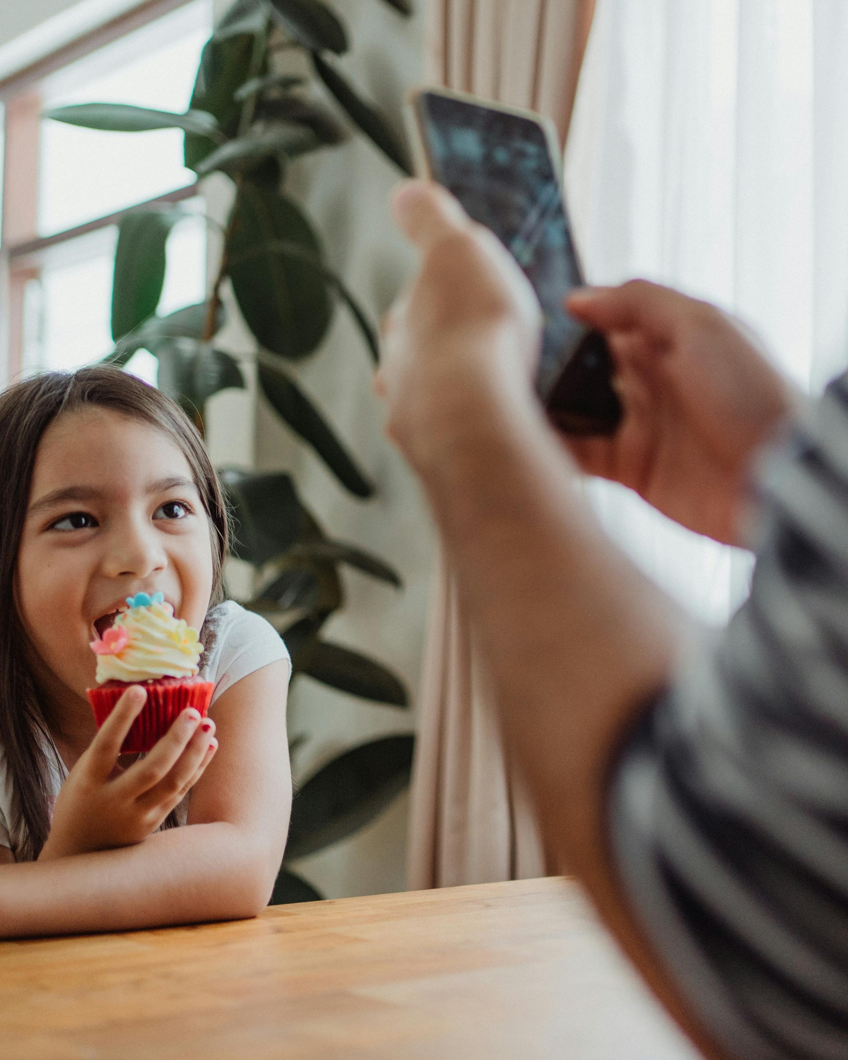 Taking Photo of Girl With Cupcake