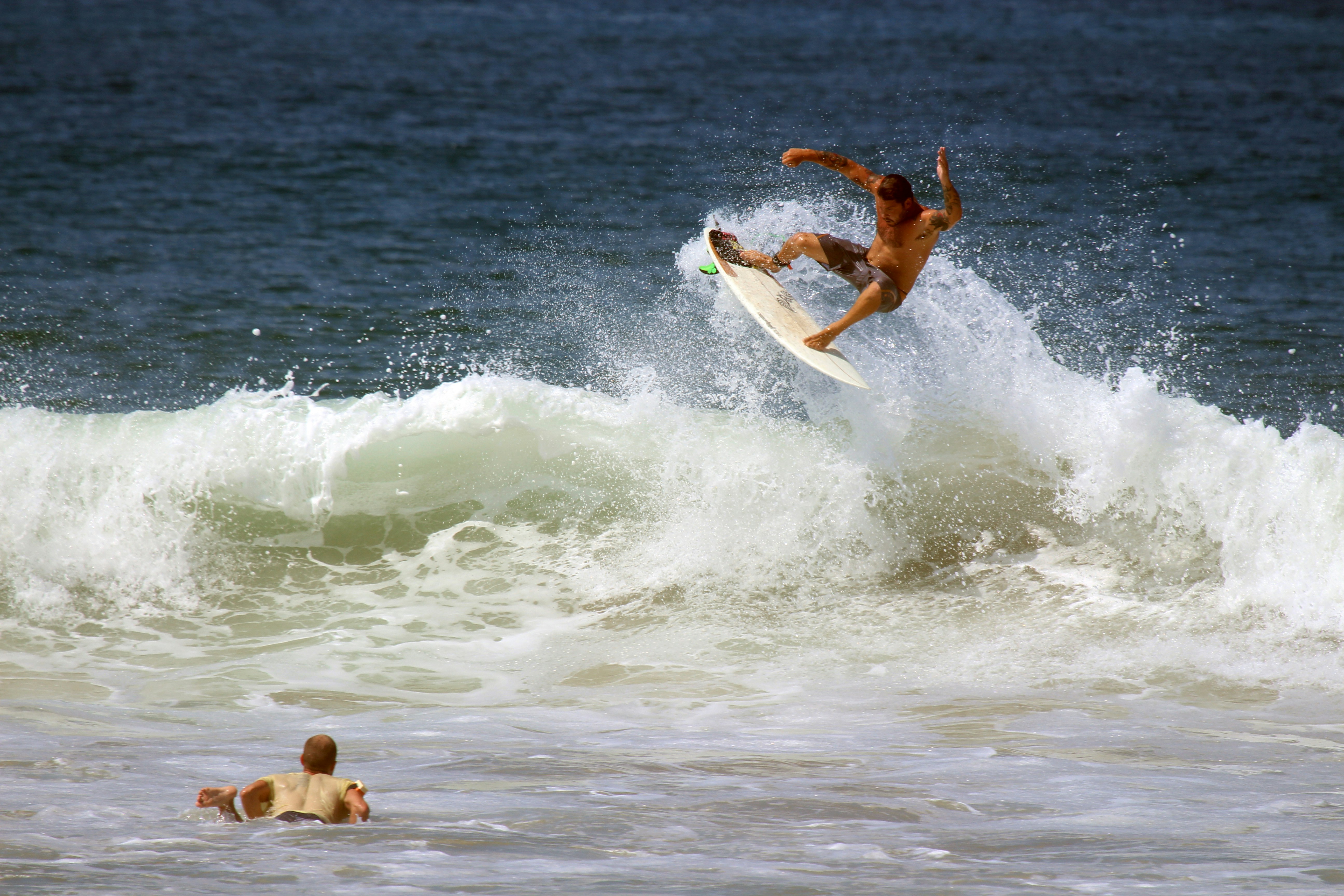 Surfer Performing Aerial Trick on Wave