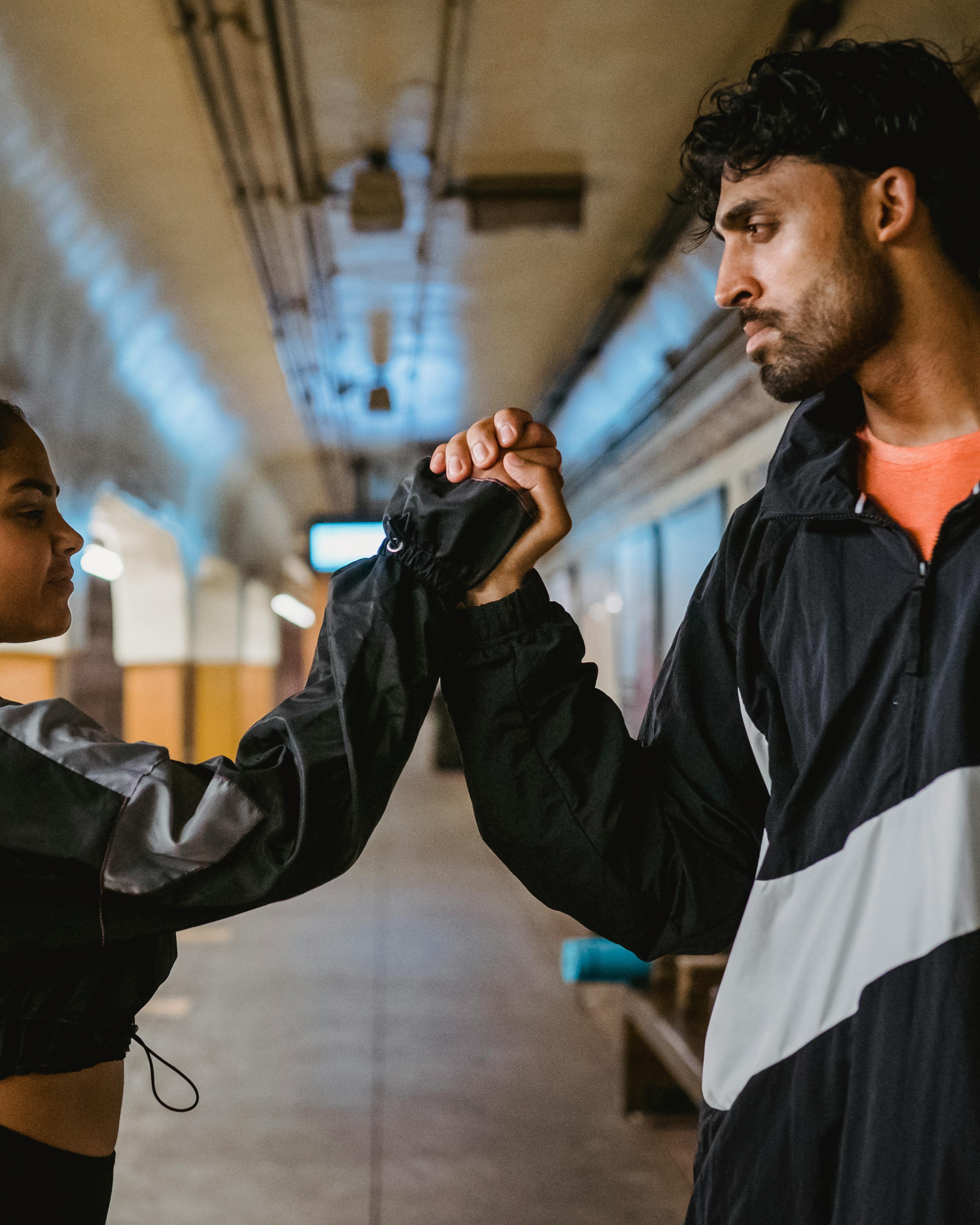Two Fitness Partners Clasping Hands