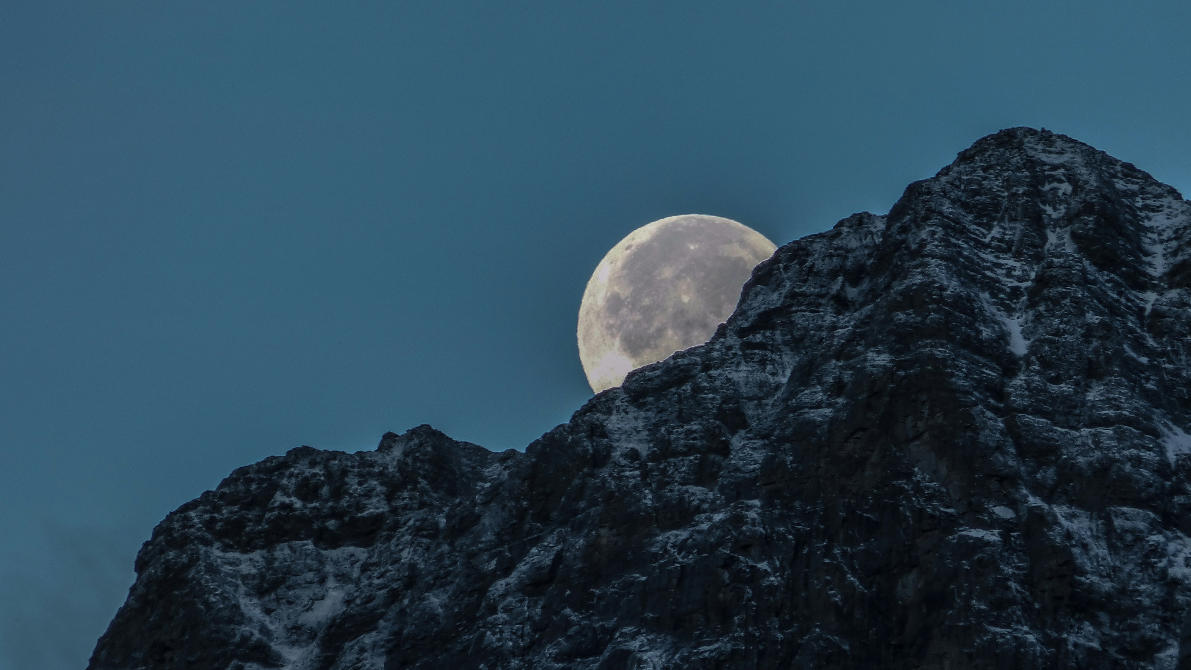 Full Moon Behind Snowy Mountain