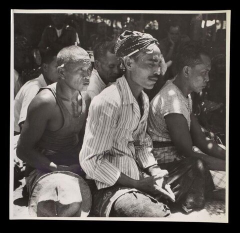 Three Seated Men at Outdoor Gathering