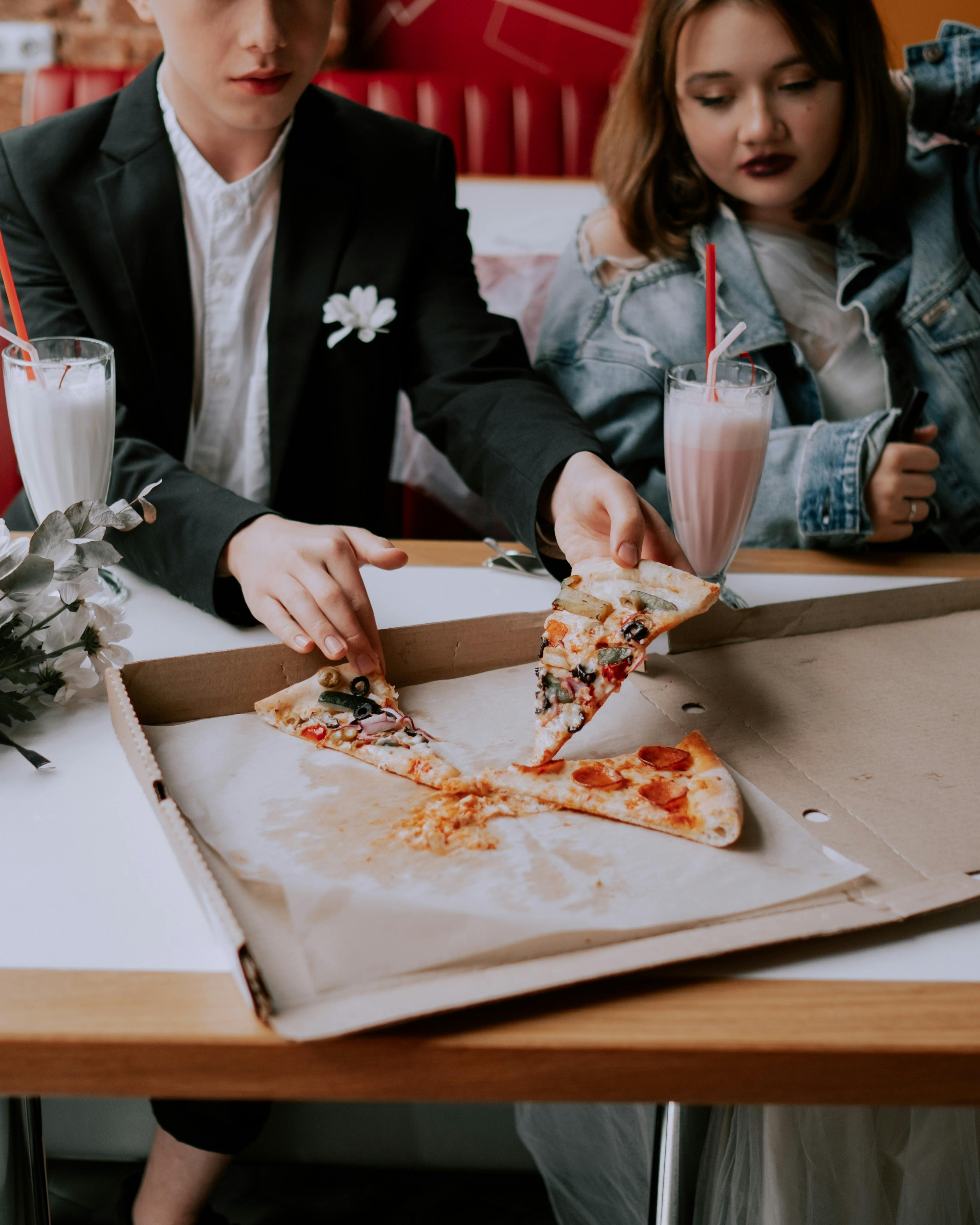 Two People Sharing Pizza