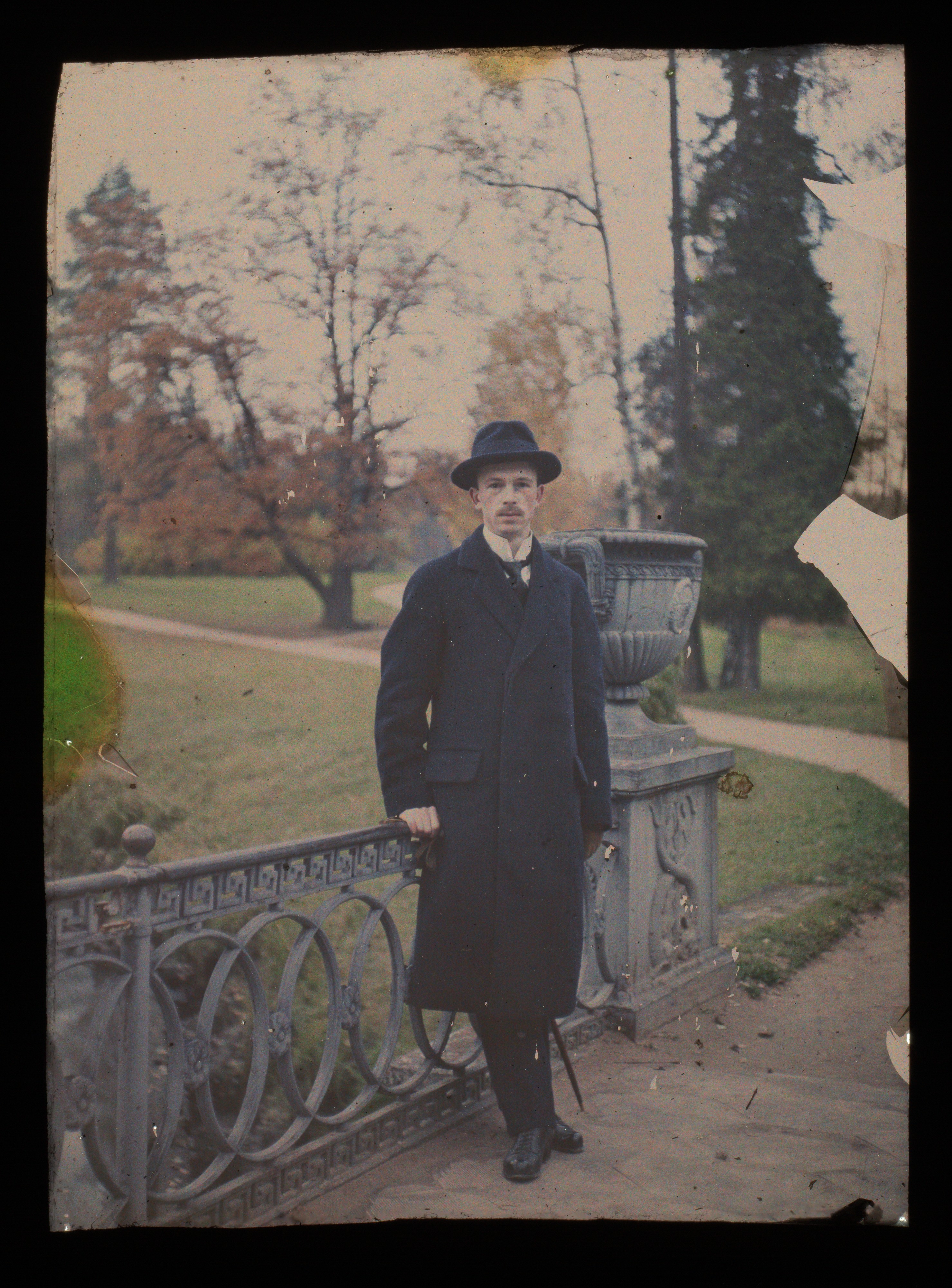 Man in Hat Standing in Autumn Park