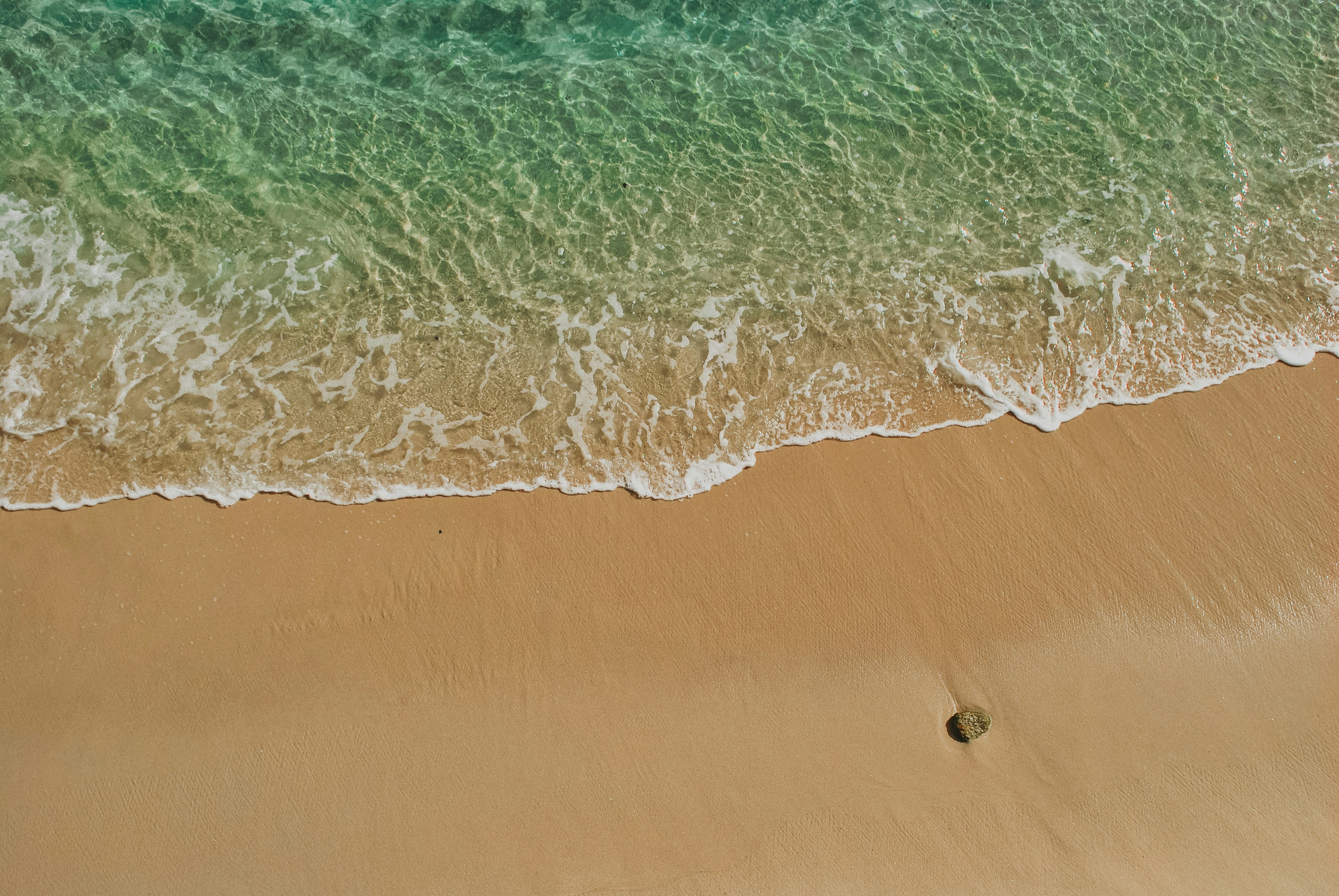 Wave Rolling onto Sandy Beach