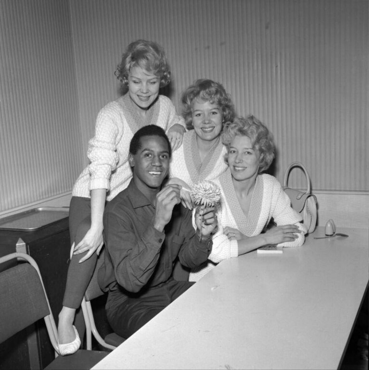 One man and three women posing for photo