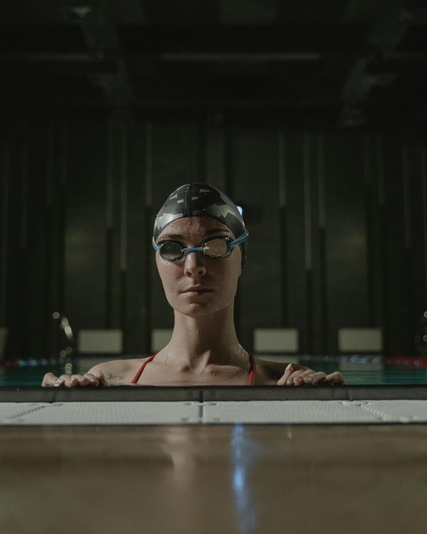 Female Swimmer at Indoor Pool Edge