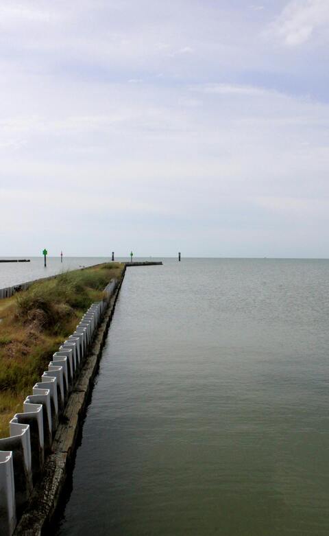Breakwater Extending Into Calm Sea