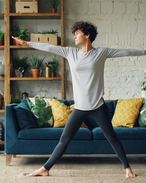 Woman Doing Yoga In Living Room