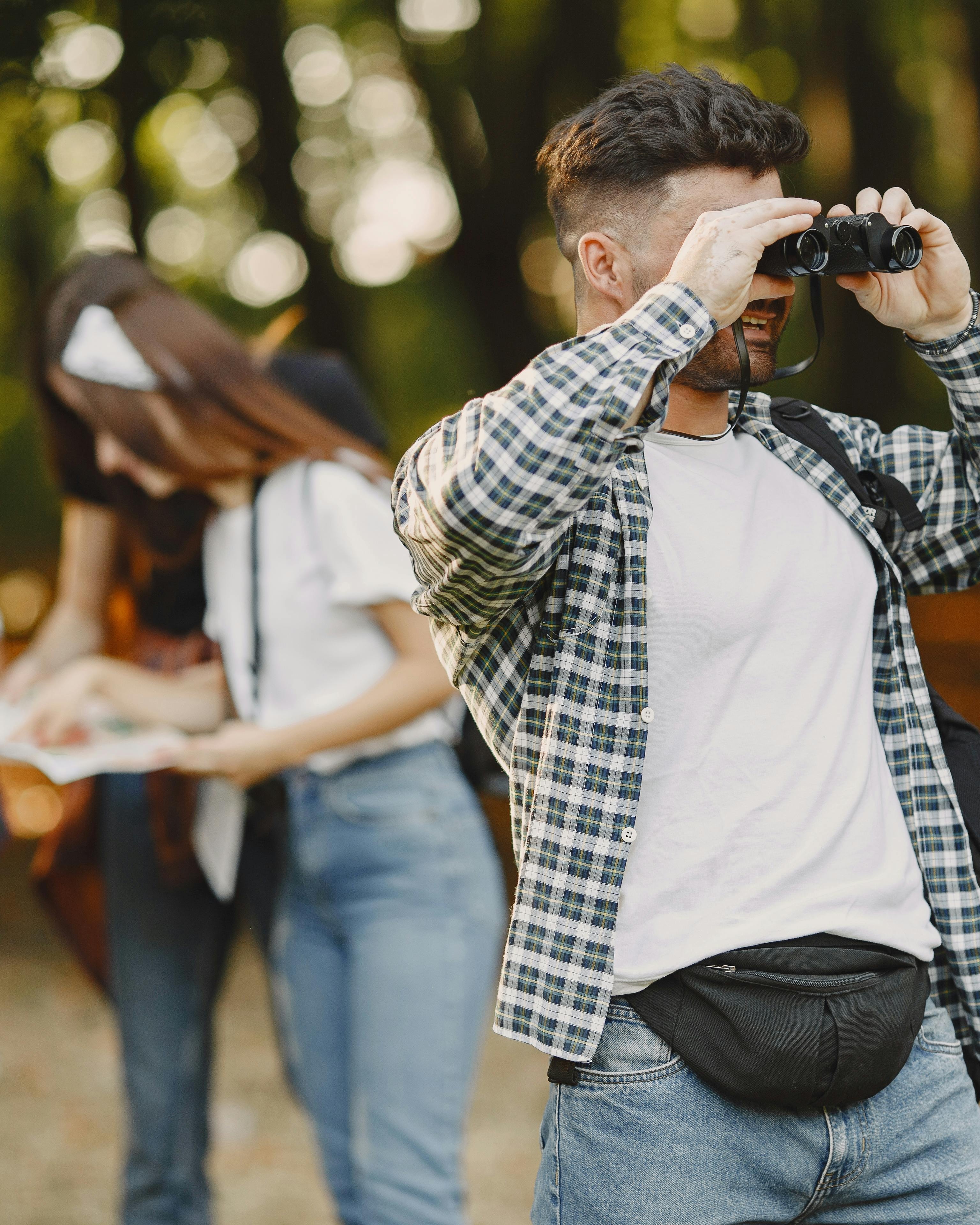 Hiker Using Binoculars on Forest Hike
