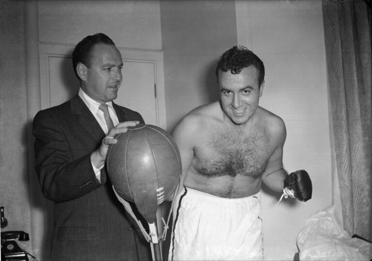 Boxer and Trainer With Punching Bag