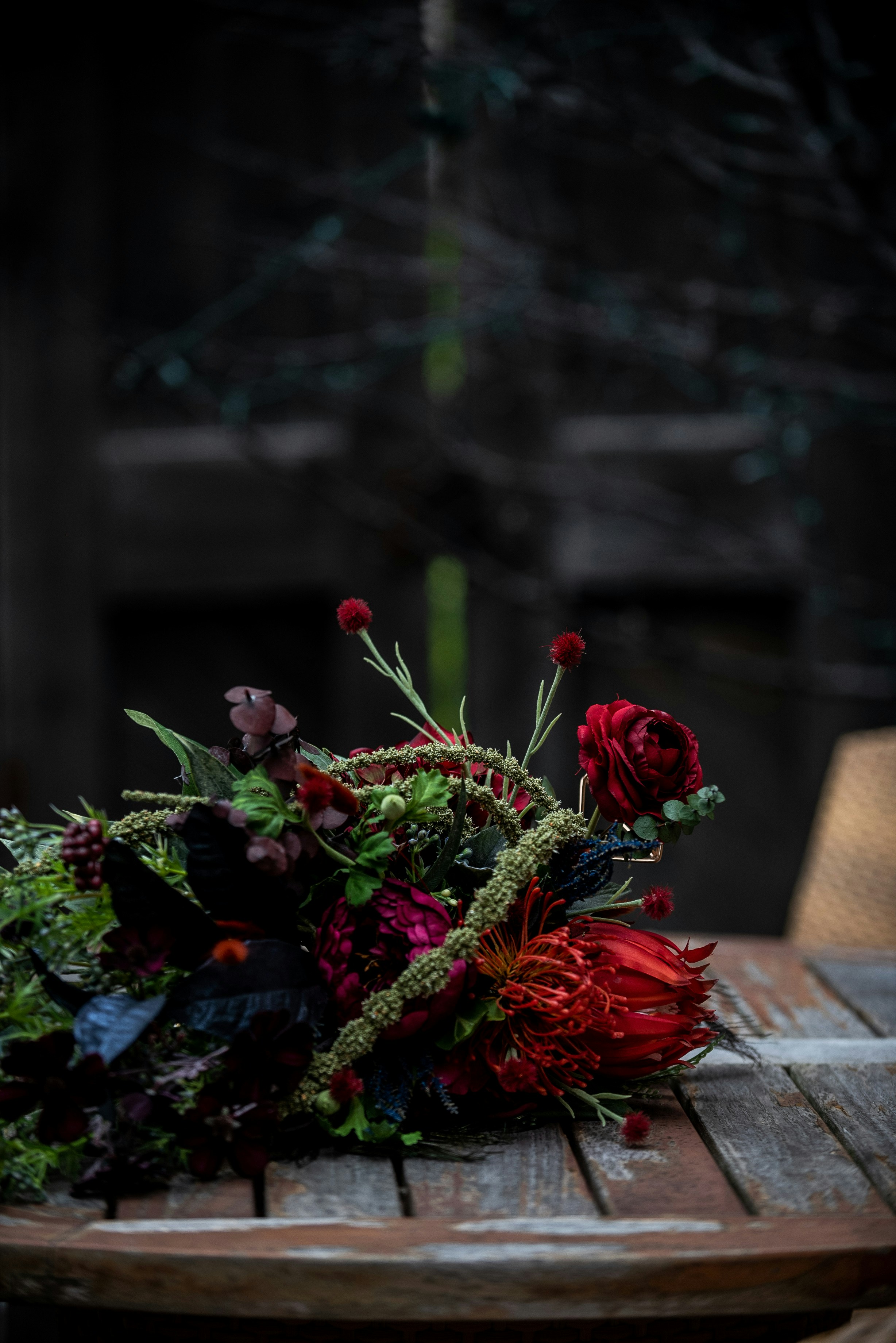 Dark Red Flower Arrangement on Wooden Table