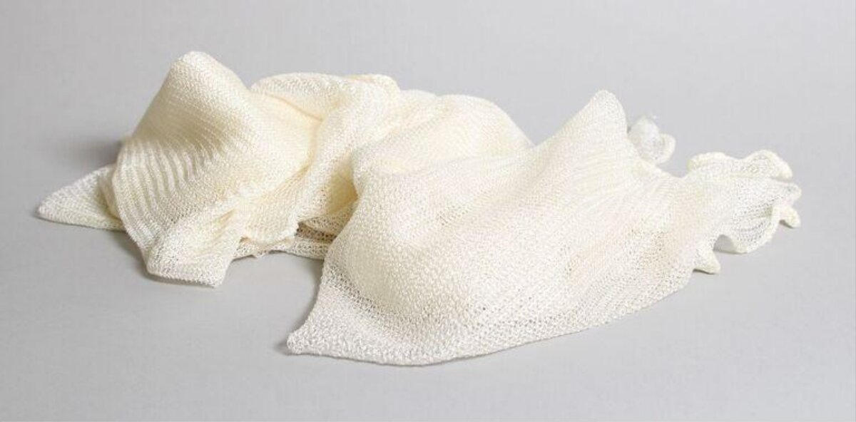 Cream Knitted Scarf on Gray Background