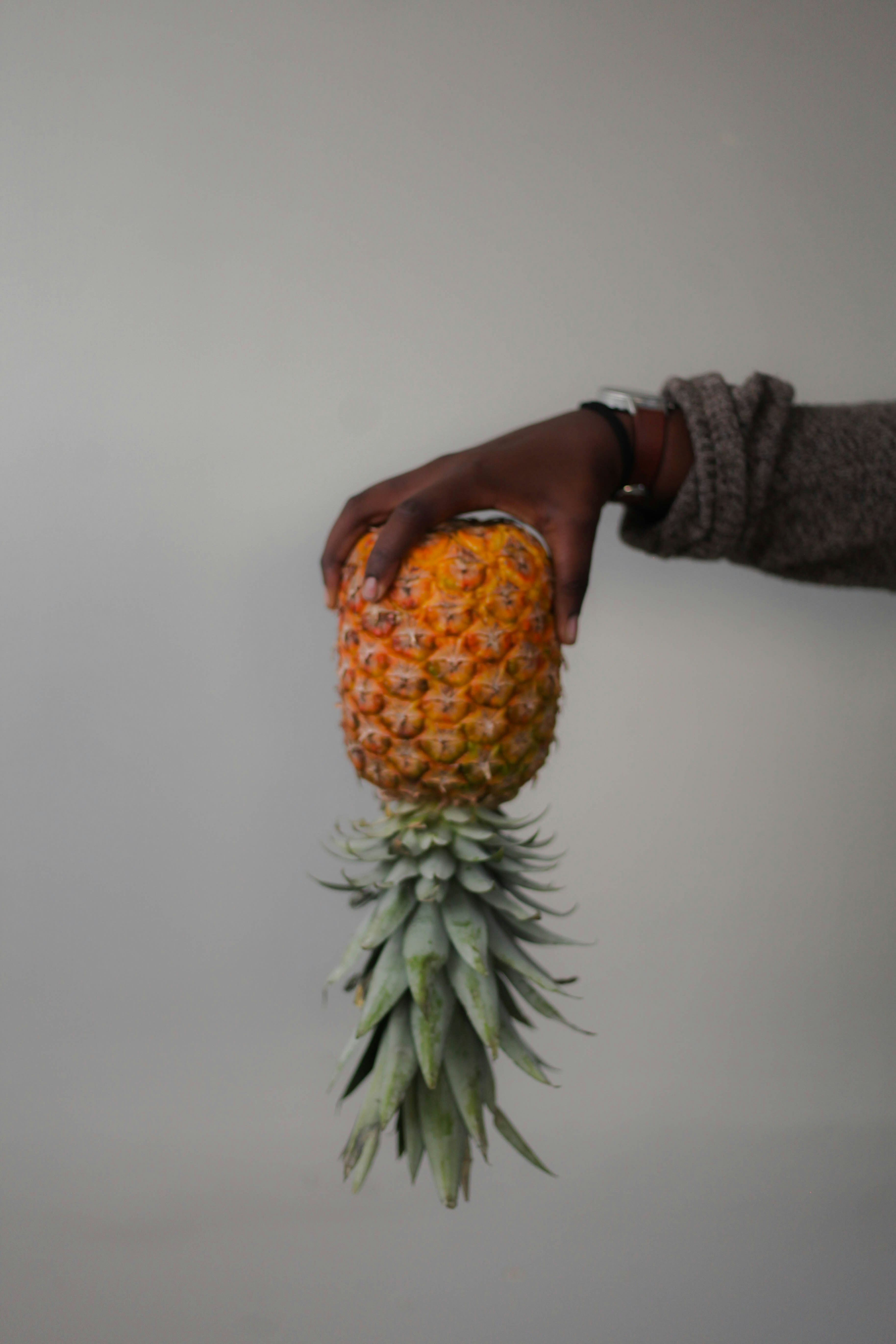 Hand Holding Inverted Pineapple
