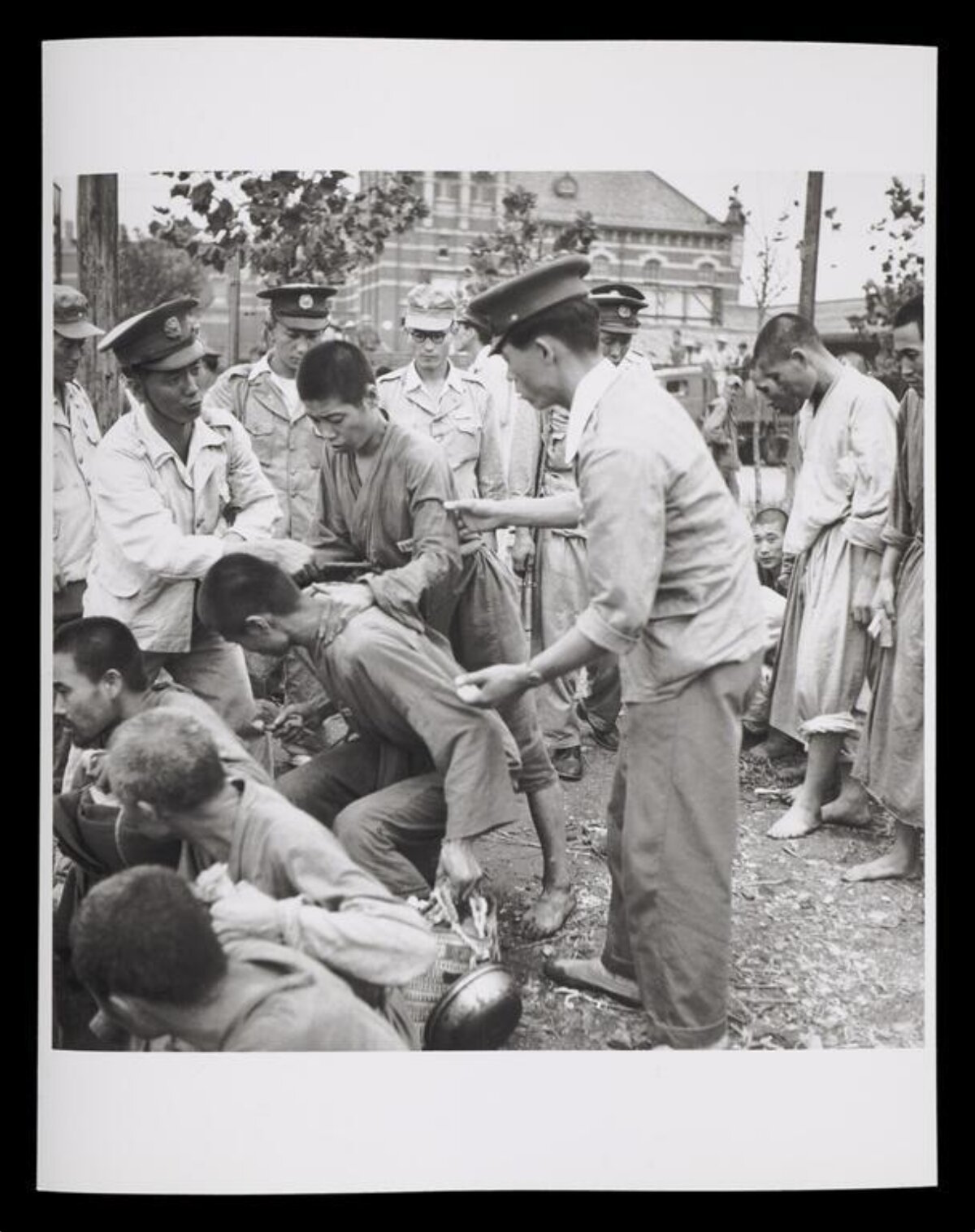 Soldiers processing detained prisoners