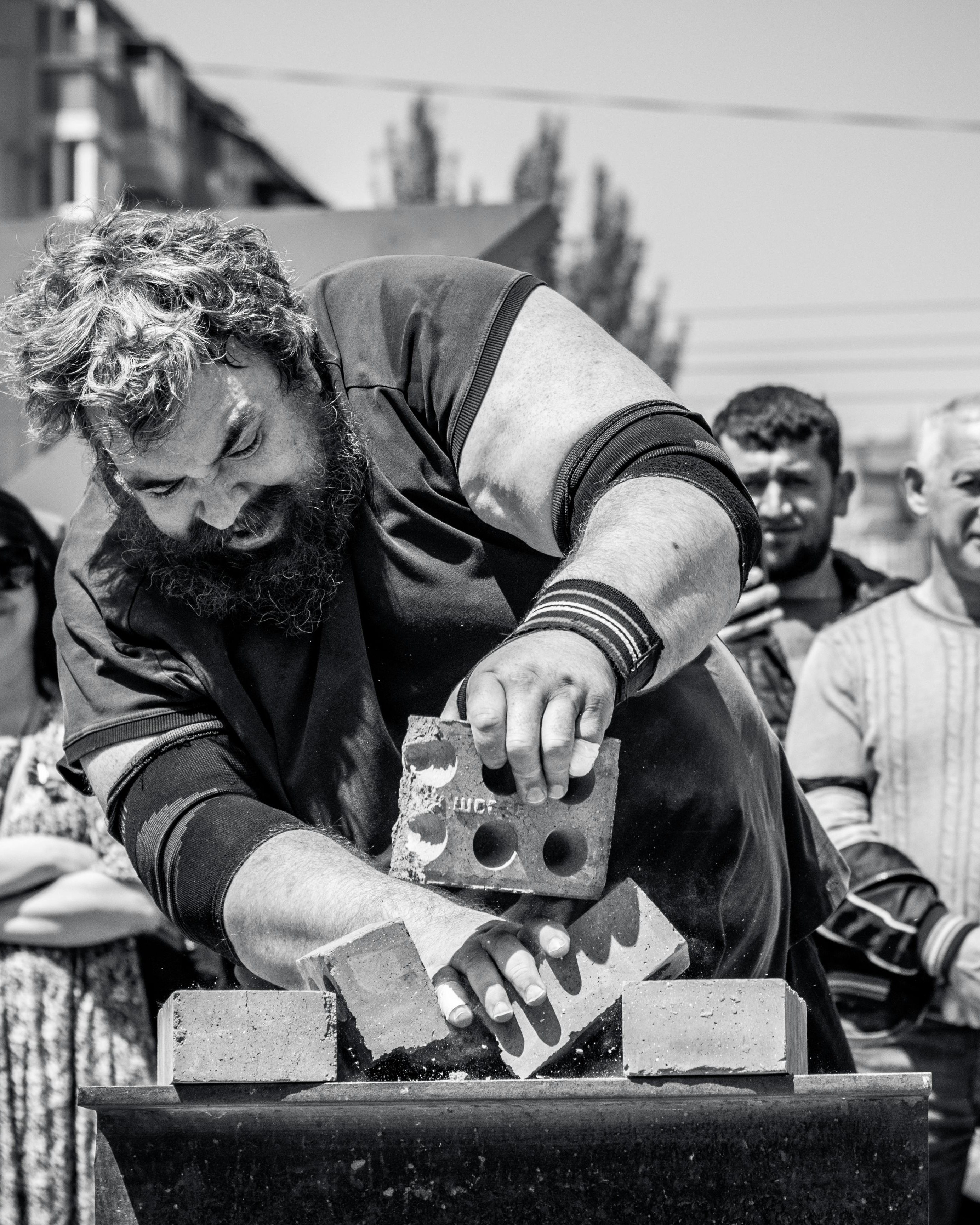 Strongman Breaking Bricks Outdoors