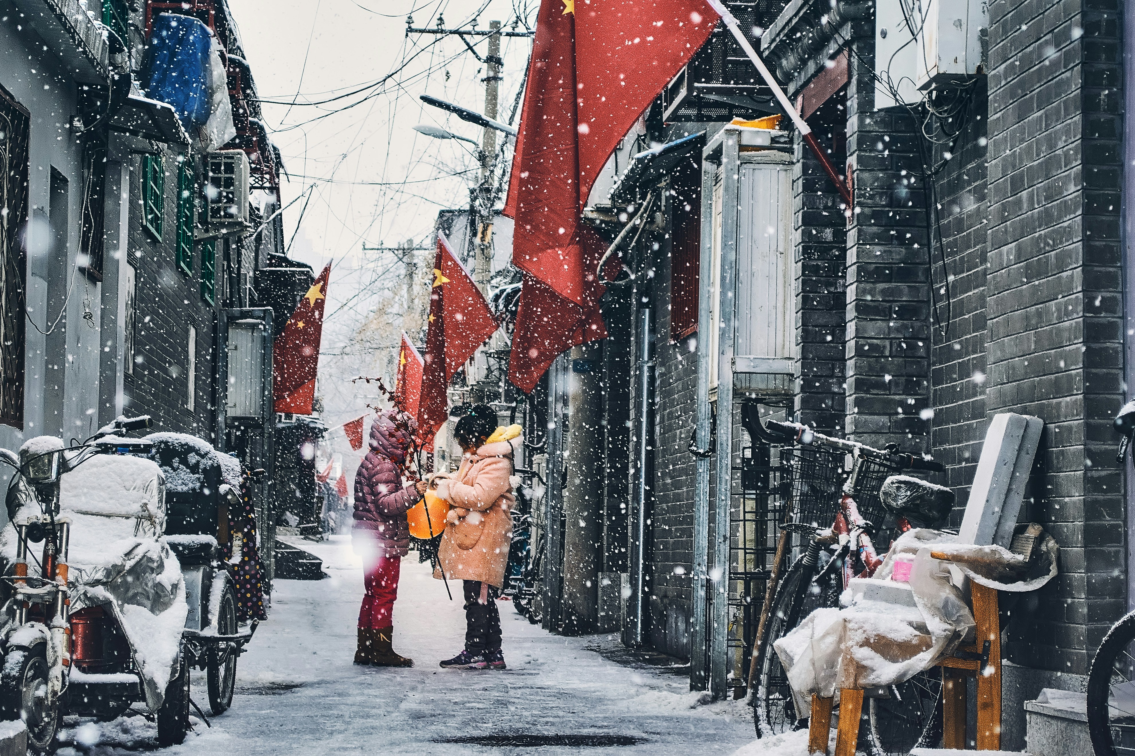 Snowy Hutong Alley with National Flags