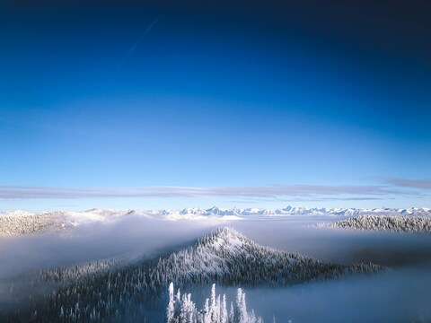 Snowy Mountain Landscape Above Fog