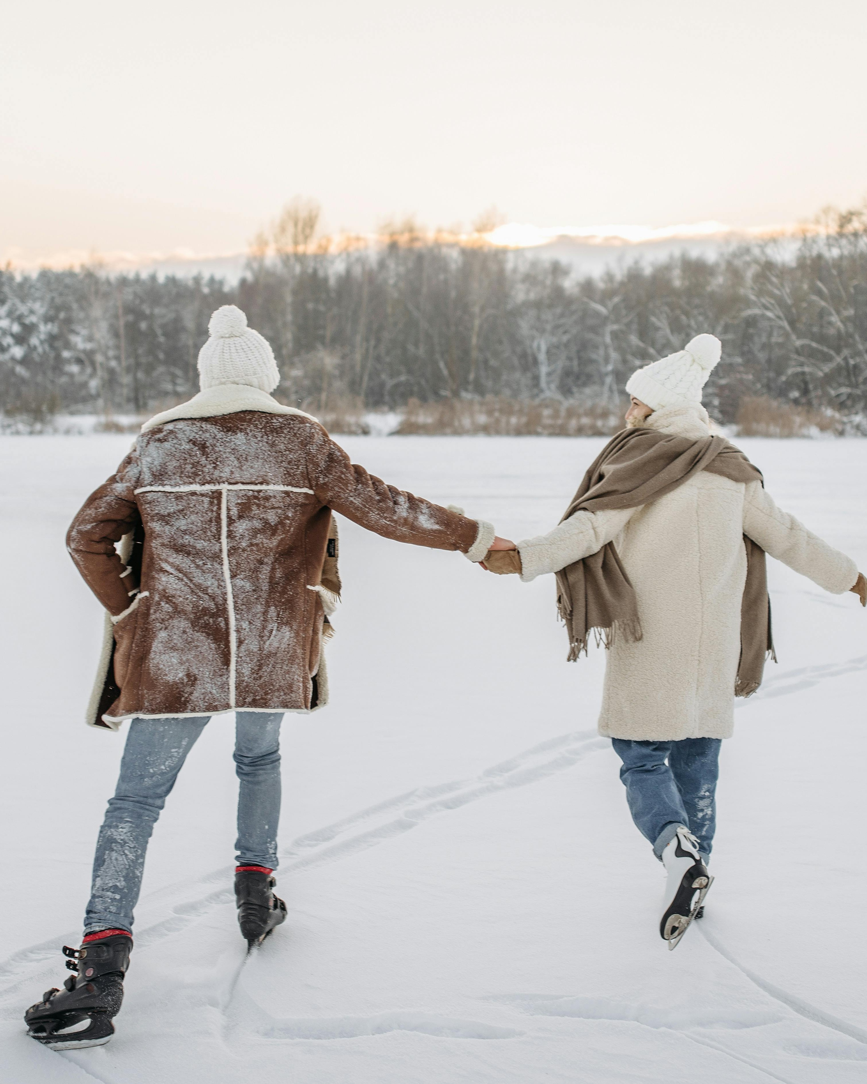 Couple Ice Skating on Frozen Winter Lake