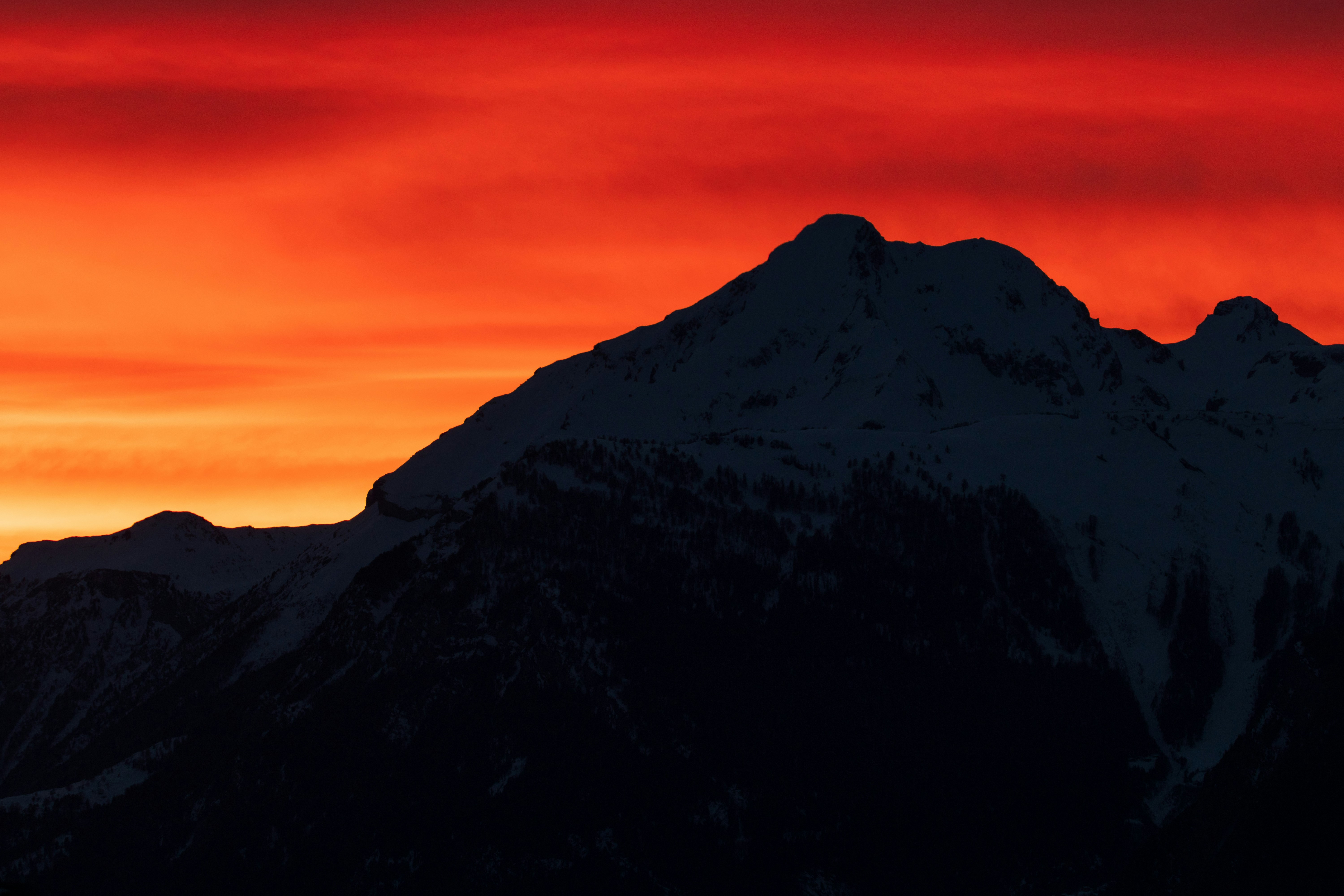 Snow Mountain Silhouette at Red Sunset