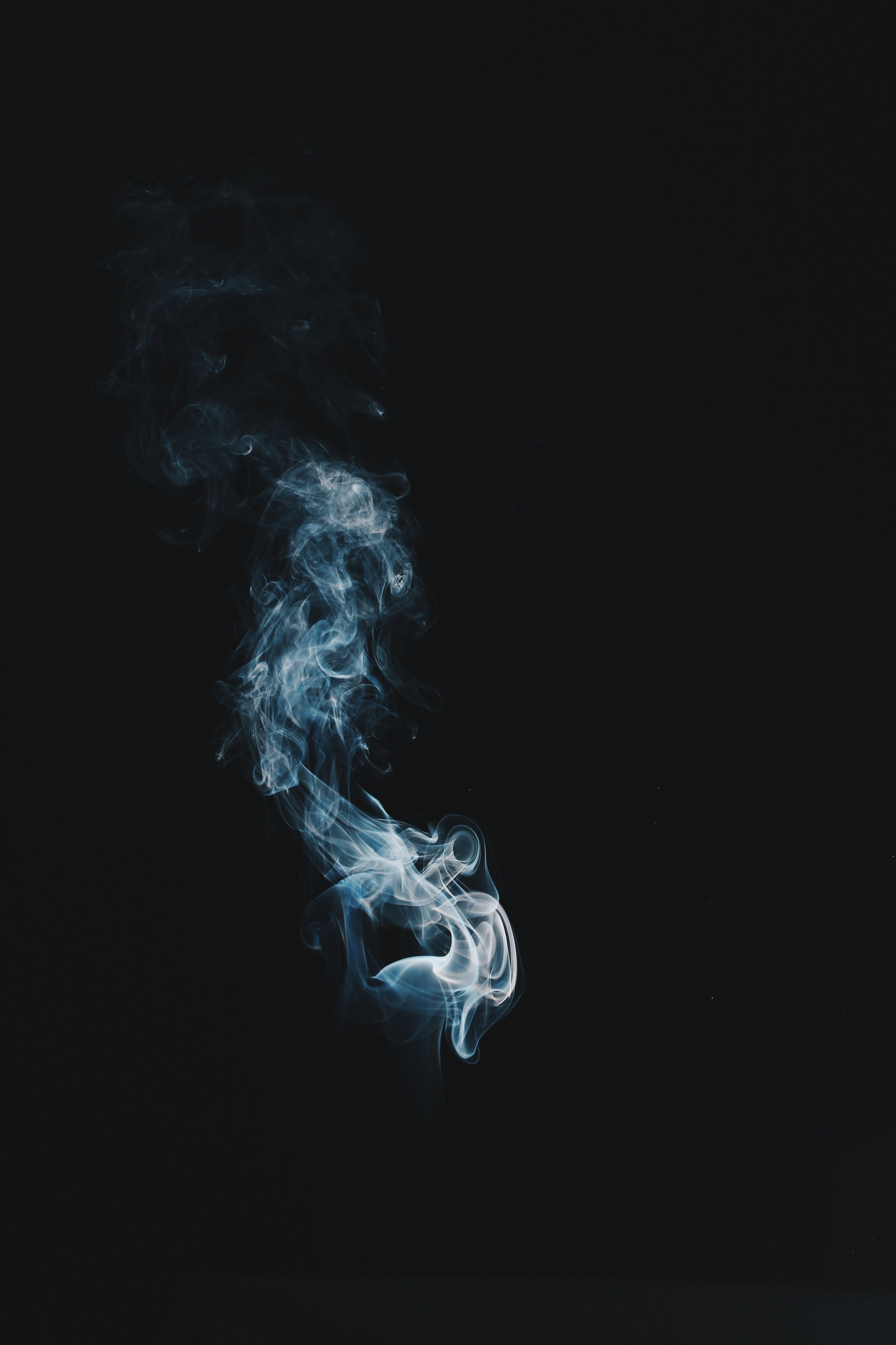 Wispy Smoke Against Black Background