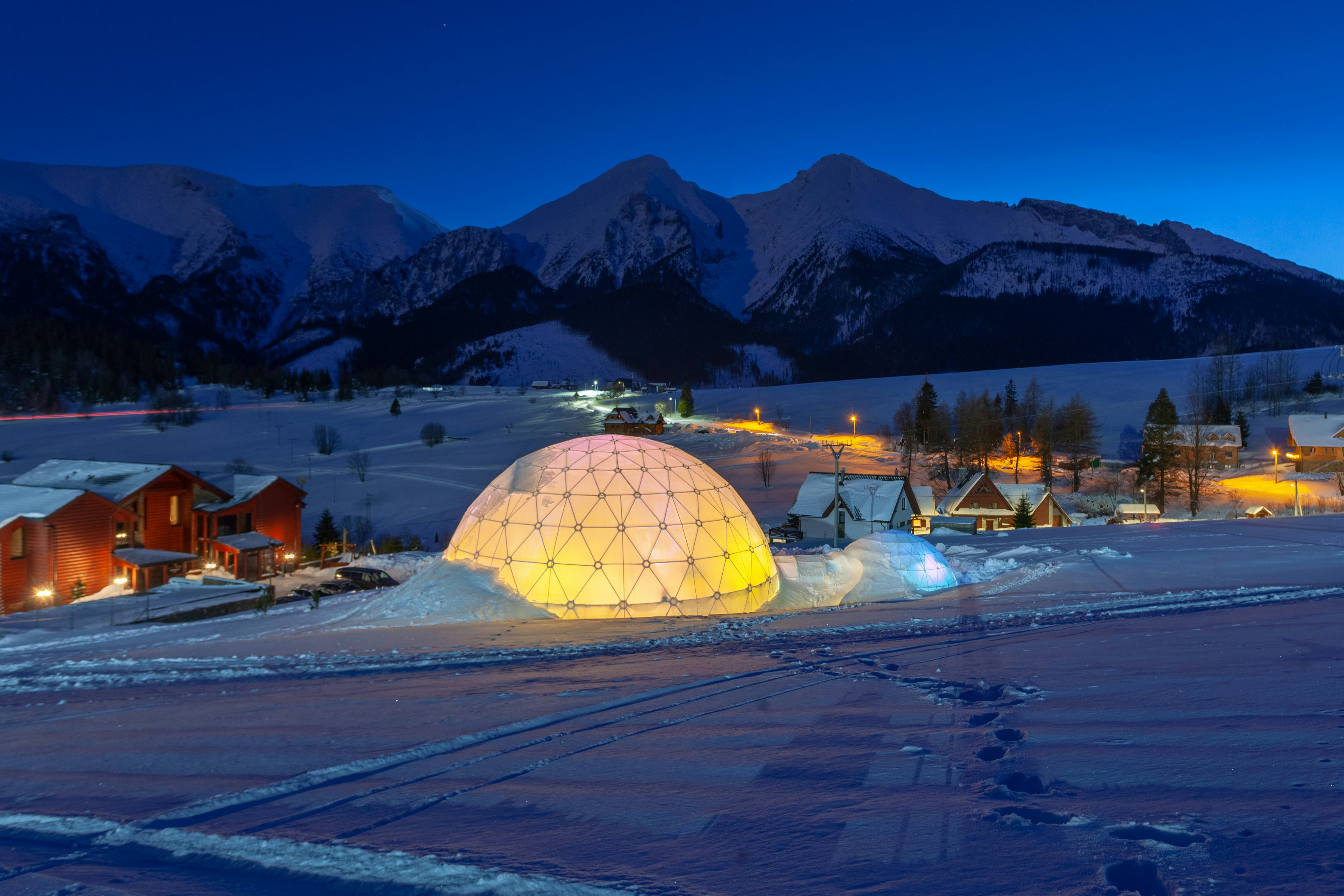 Glowing Domes in Snowy Mountain Night