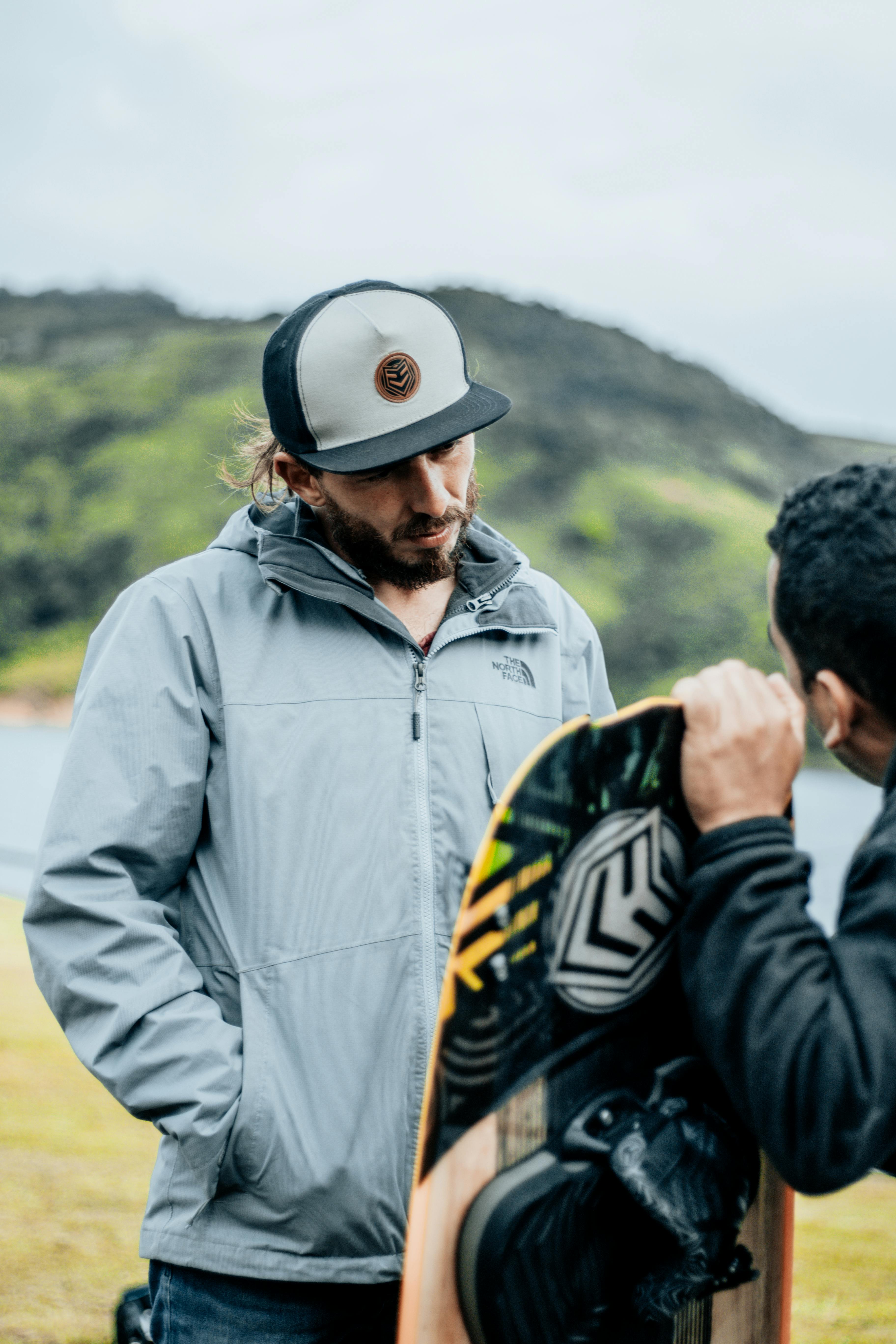 Two Men By Lake With Wakeboard