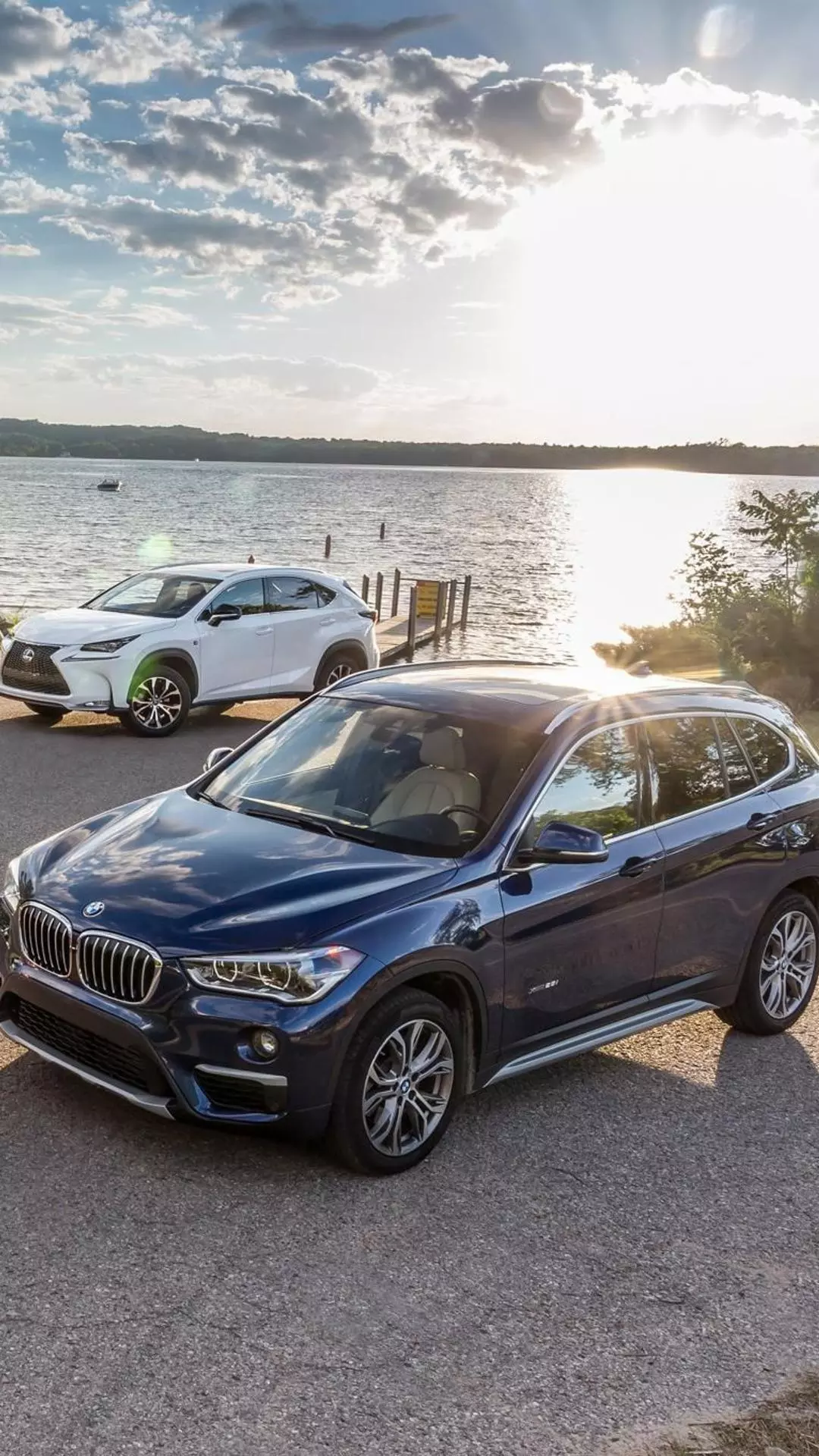 Two SUVs Parked by a Lake