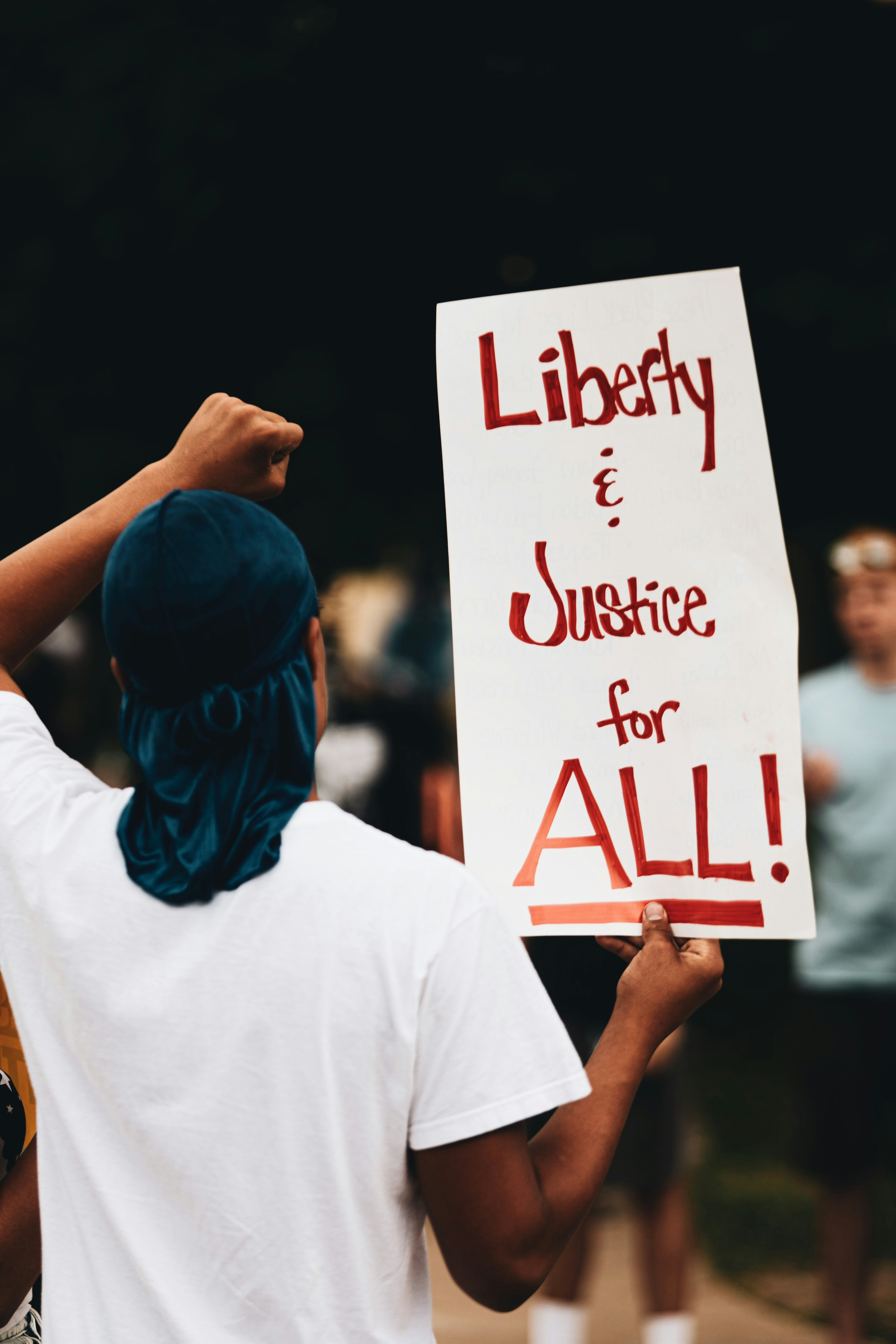 Protestor with Liberty and Justice for All Sign
