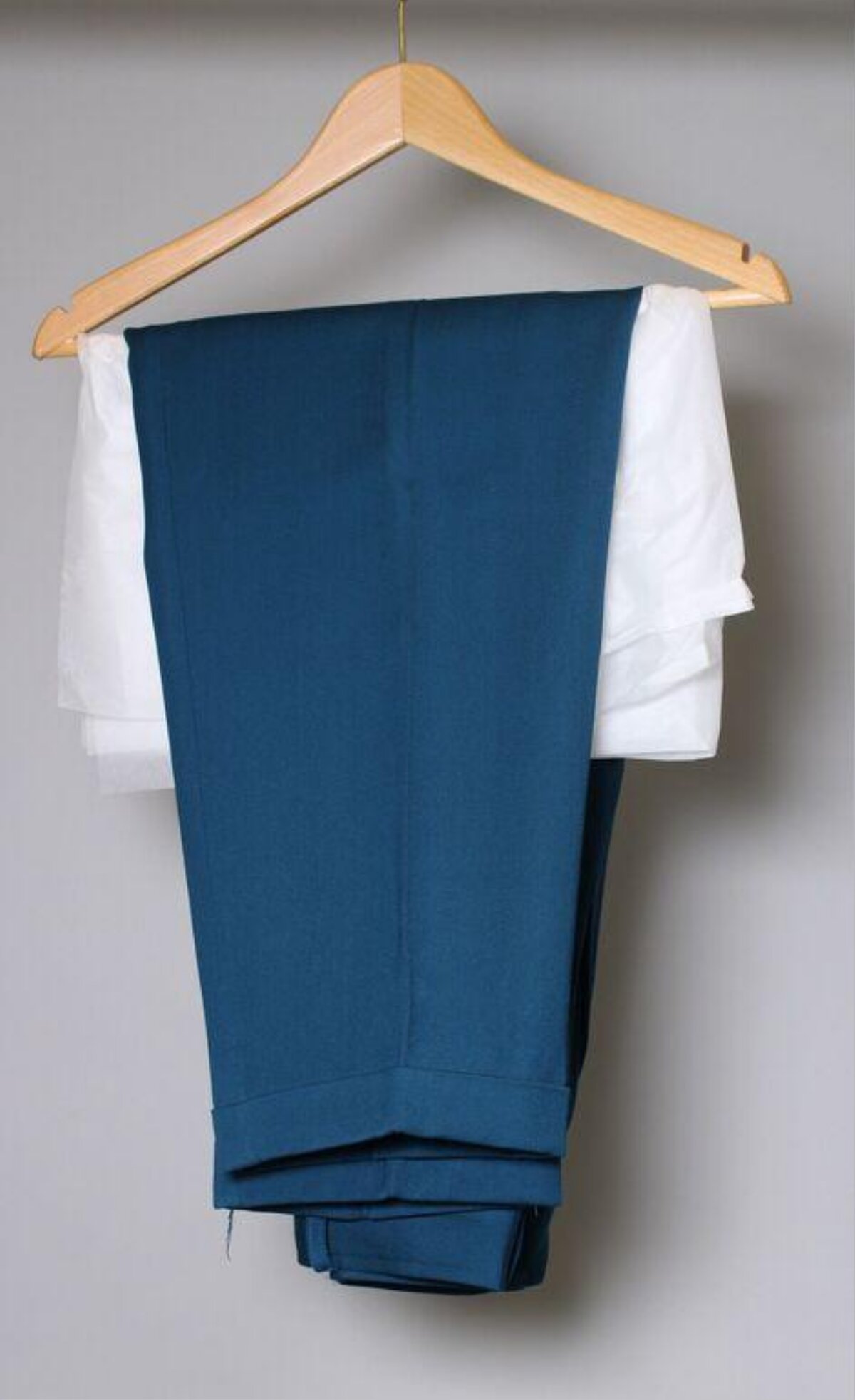Folded Shirt and Trousers on Wooden Hanger