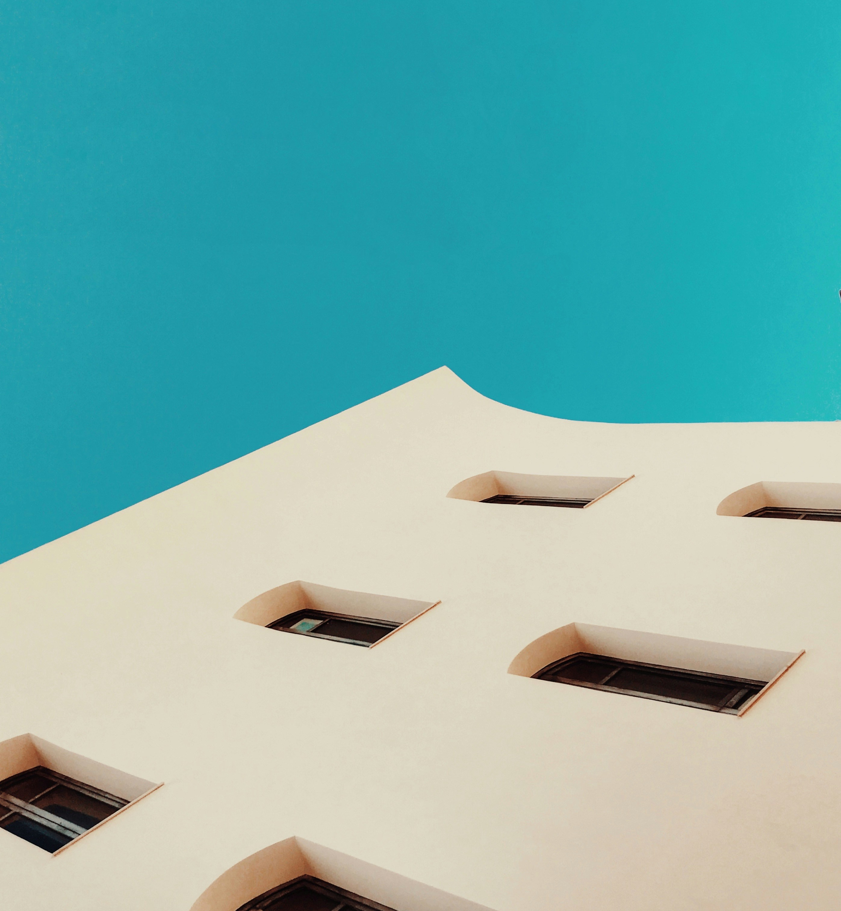 Low Angle Shot of Building Against Blue Sky