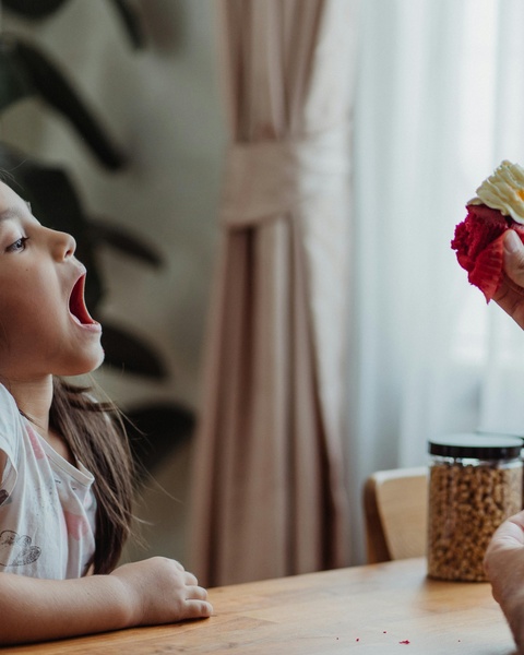 Girl Opening Mouth For Cupcake